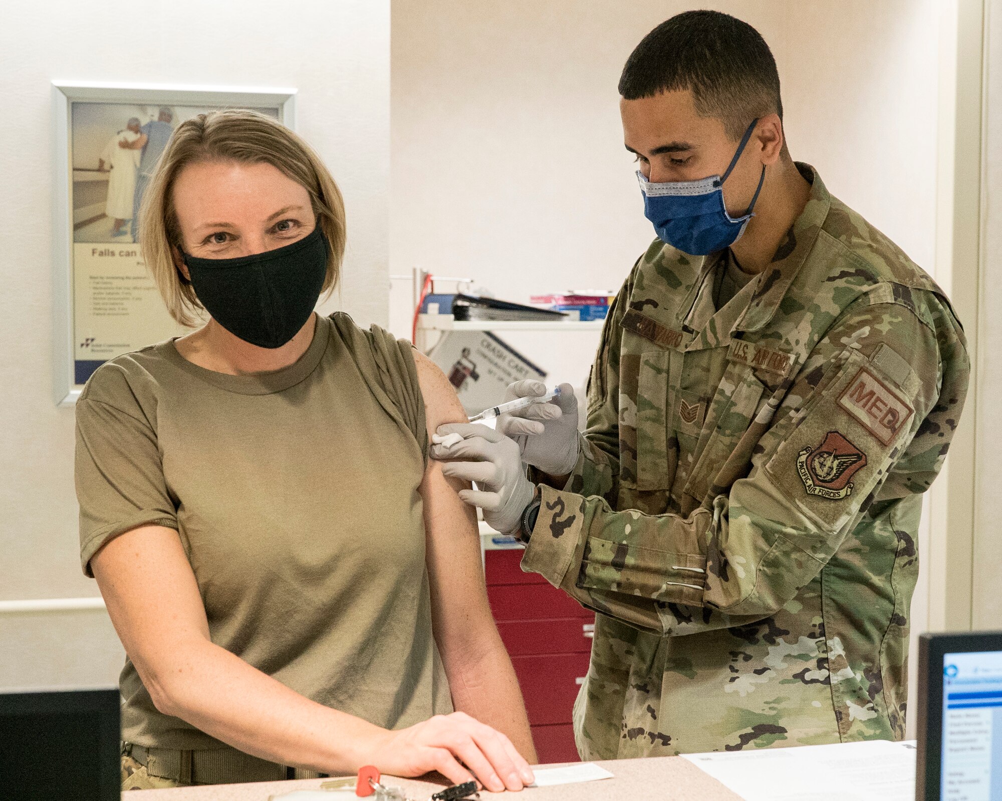 U.S. Air Force Tech. Sgt. Orlando Navarro, 673d Medical Operations Squadron noncommissioned officer in charge of the Allergy and Immunization Clinic, inoculates U.S. Air Force Col. Kirsten Aguilar, Joint Base Elmendorf-Richardson and 673d Air Base Wing commander, with her flu shot during a 673d MDOS immersion tour at JBER, Alaska, Sept. 24, 2020. Aguilar familiarized herself with the 673d MDOS and its role in supporting installation readiness after taking command of the installation on July 14, 2020. The 673d MDOS works to enhance the performance and overall health of JBER in order to ensure combat effectiveness. (U.S. Air Force photo by Senior Airman Crystal A. Jenkins)