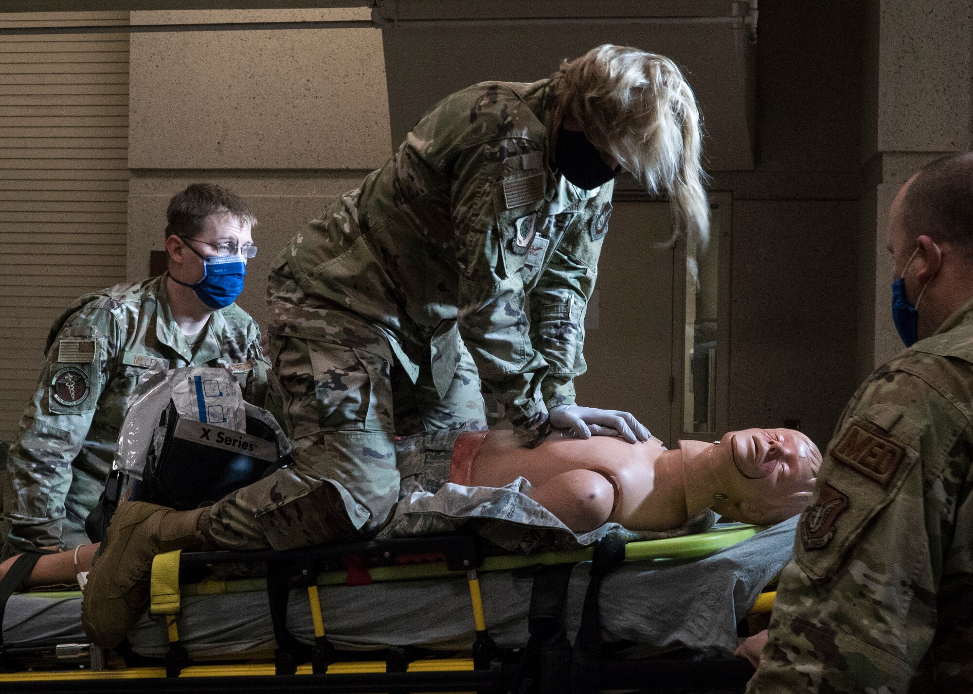 U.S. Air Force Col. Kirsten Aguilar, Joint Base Elmendorf-Richardson and 673d Air Base Wing commander, performs chest compressions during an exercise on a high fidelity manikin while U.S. Air Force Tech. Sgt. Benjamin Miller, paramedic, and U.S. Air Force Tech Sgt. Brock Ashbaugh, paramedic, assist in lifting the gurney from an ambulance during a 673d Medical Operations Squadron immersion tour at JBER, Alaska, Sept. 24, 2020. Aguilar familiarized herself with the 673d MDOS and its role in supporting installation readiness after taking command of the installation on July 14, 2020. The 673d MDOS works to enhance the performance and overall health of JBER in order to ensure combat effectiveness. (U.S. Air Force photo by Senior Airman Crystal A. Jenkins)