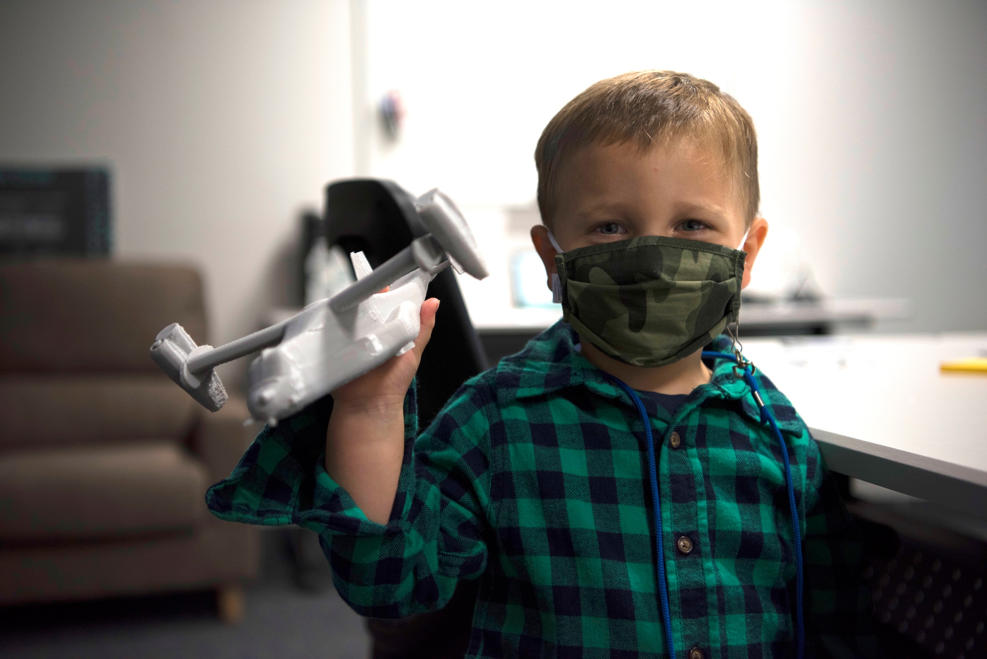 Finley Wilson, son of Master Sgt. Daniel Wilson, 5th Air Force intelligence, surveillance, reconnaissance and cyber effects operations superintendent, plays with a 3D print of a CV-22 Osprey in the newly-opened innovation lab at Yokota Air Base, Japan, Sept. 25, 2020. The lab is a dedicated space filled with tools and resources to collaboratively solve problems. (U.S. Air Force photo by Staff Sgt. Taylor A. Workman)