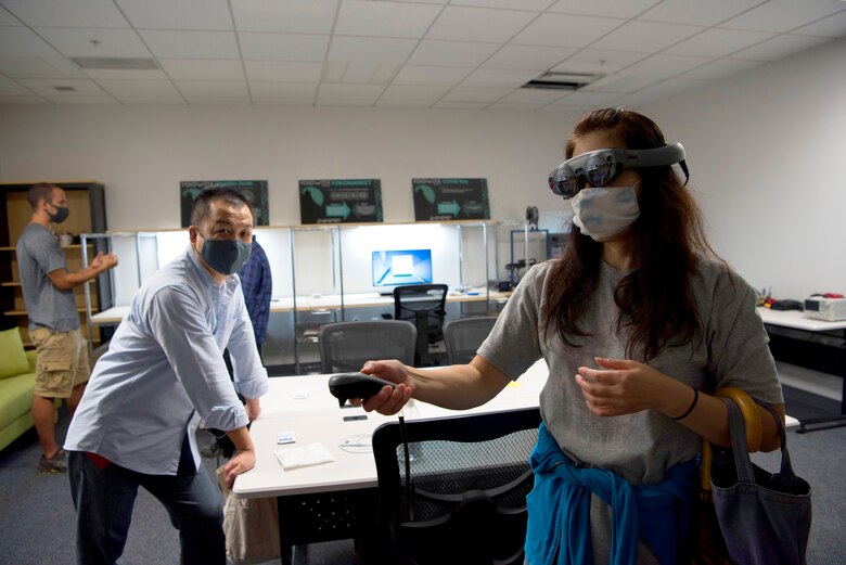 Kayoko Seta, 374th Contracting Squadron contracting specialist, experiences augmented reality for the first time in the newly-opened innovation lab at Yokota Air Base, Japan, Sept. 25, 2020. The Dojo is now open for business as the installation's hub for problem-solving. (U.S. Air Force photo by Staff Sgt. Taylor A. Workman)