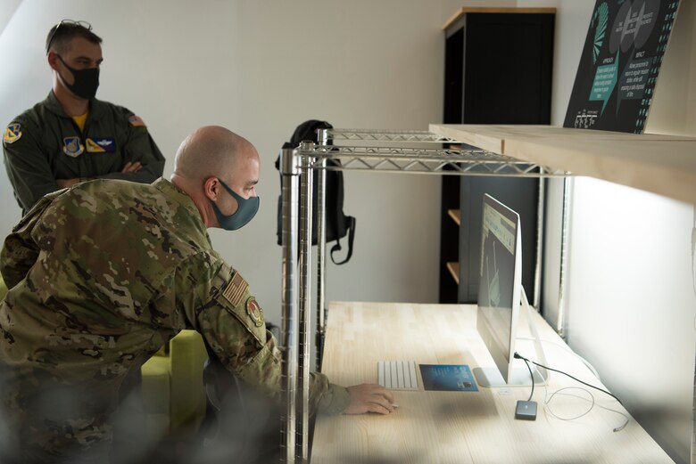Staff Sgt. Gerard Arceneaux, founder of YokoWERX and 374th Force Support Squadron manpower analyst, shows Col. Andrew Campbell, 374th Airlift Wing commander, a 3D design in the newly-opened innovation lab at Yokota Air Base, Japan, Sept. 25, 2020. The lab is a dedicated space filled with tools and resources to collaboratively solve problems. (U.S. Air Force photo by Staff Sgt. Taylor A. Workman)