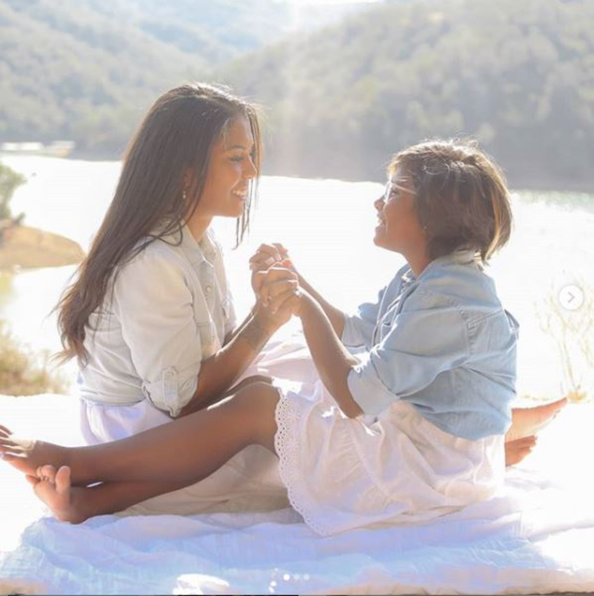 Airman and daughter fit for family photo in front of lake