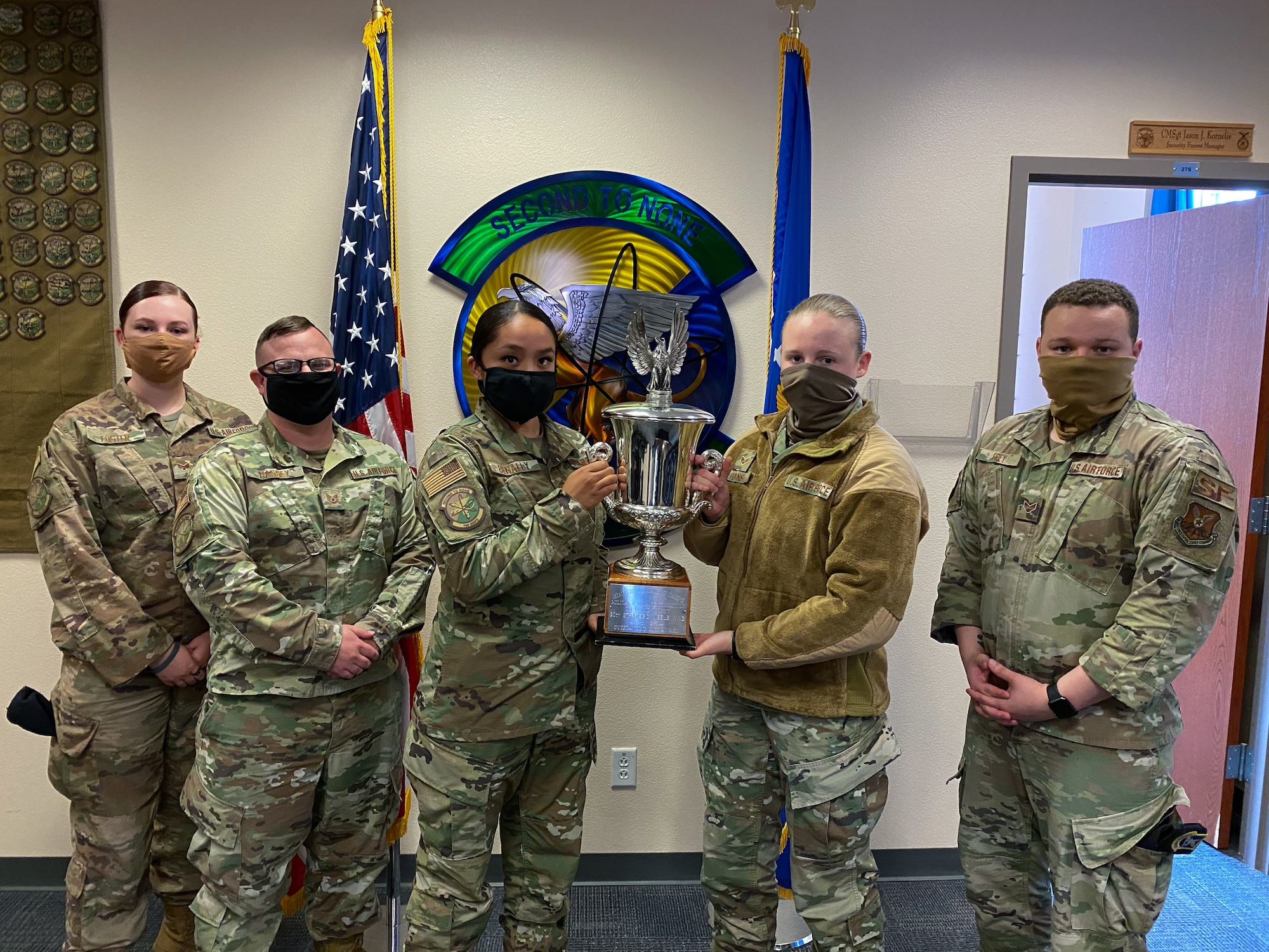 The 790th Missile Security Forces Squadron Airmen pose for photos with the Cheyenne Trophy on F.E. Warren Air Force Base, Wyoming, Sept. 10, 2020. The Greater Cheyenne Chamber of Commerce recently presented the Military Affairs Committee’s Cheyenne Trophy to the 790th Missile Security Force Squadron for mission accomplishments, patriotism, off-duty volunteerism and community involvement resulting in a positive impact on the city of Cheyenne and its residents. (U.S. Air Force photos by Joseph Coslett)