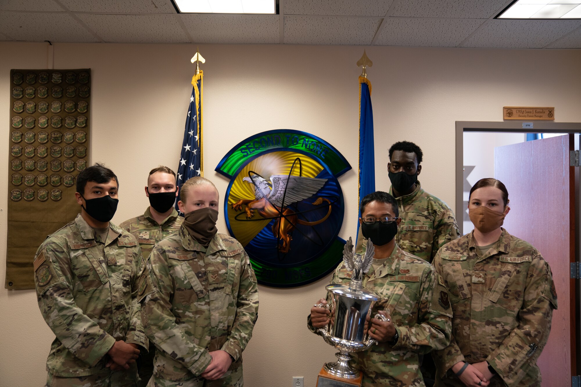 The 790th Missile Security Forces Squadron Airmen pose for photos with the Cheyenne Trophy on F.E. Warren Air Force Base, Wyoming, Sept. 10, 2020. The Greater Cheyenne Chamber of Commerce recently presented the Military Affairs Committee’s Cheyenne Trophy to the 790th Missile Security Force Squadron for mission accomplishments, patriotism, off-duty volunteerism and community involvement resulting in a positive impact on the city of Cheyenne and its residents. (U.S. Air Force photos by Joseph Coslett)