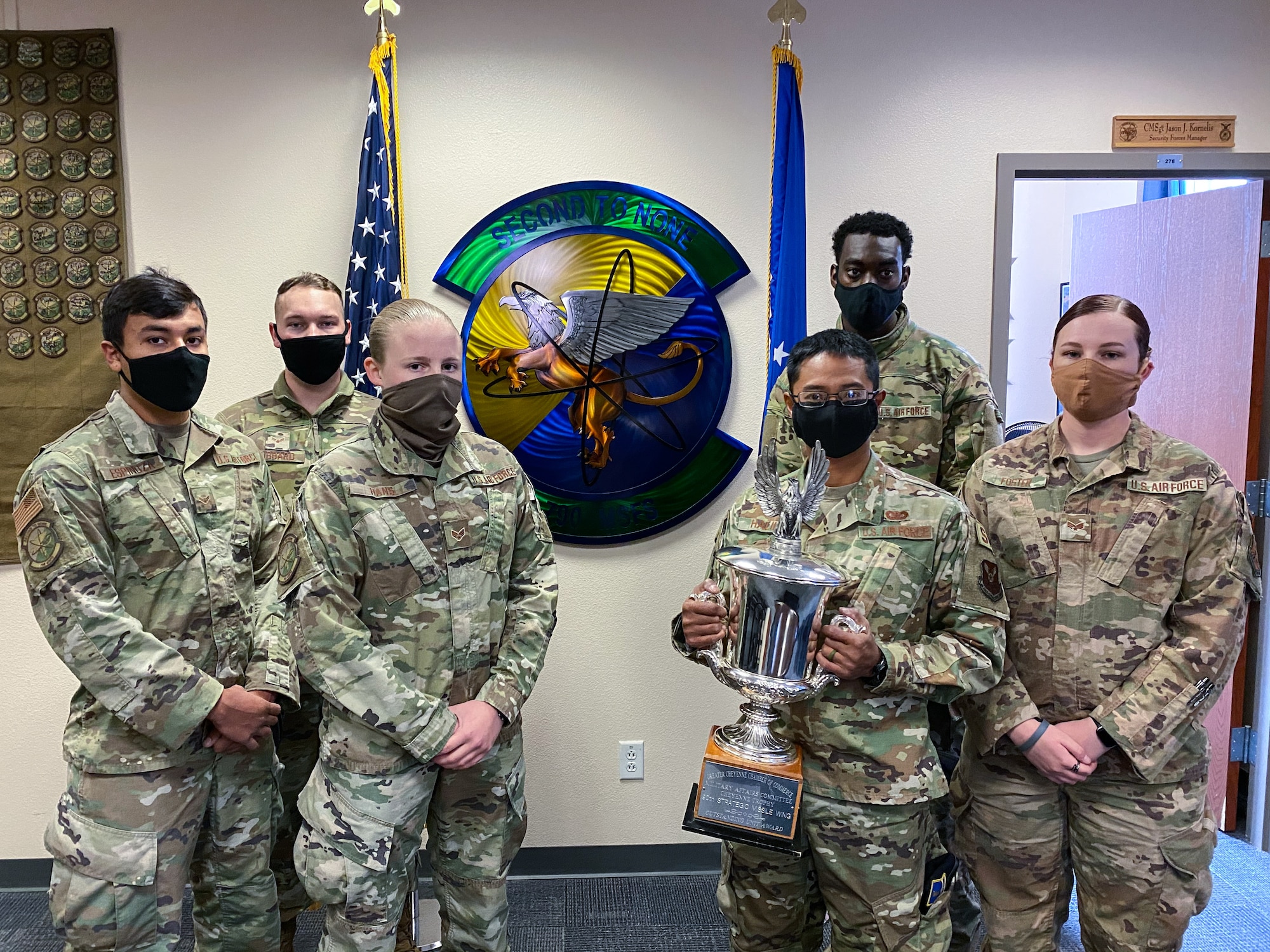 The 790th Missile Security Forces Squadron Airmen pose for photos with the Cheyenne Trophy on F.E. Warren Air Force Base, Wyoming, Sept. 10, 2020. The Greater Cheyenne Chamber of Commerce recently presented the Military Affairs Committee’s Cheyenne Trophy to the 790th Missile Security Force Squadron for mission accomplishments, patriotism, off-duty volunteerism and community involvement resulting in a positive impact on the city of Cheyenne and its residents. (U.S. Air Force photos by Joseph Coslett)