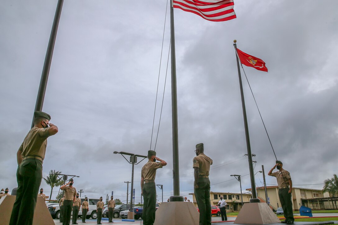 U.S. Marines and personnel assigned to Marine Corps Base (MCB) Camp Blaz observe the first flag raising of the new command, marking the initial operation capability of the base in Dededo, Guam, Oct. 1, 2020. MCB Camp Blaz is the first new Marine Corps base activated since March 1, 1952 and will hold an activation ceremony in the spring of 2021.