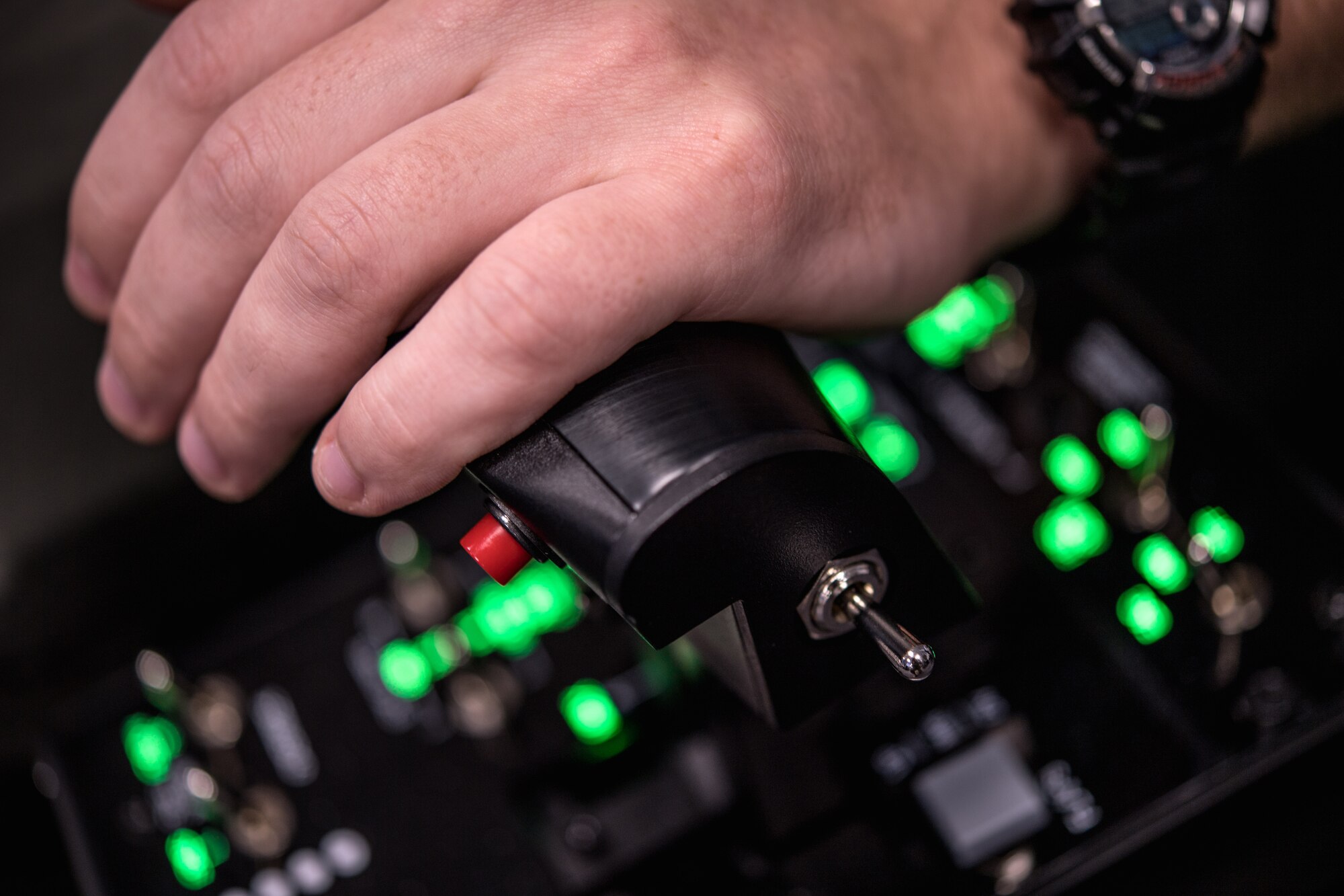 Photo of a hand on a flight simulator control console