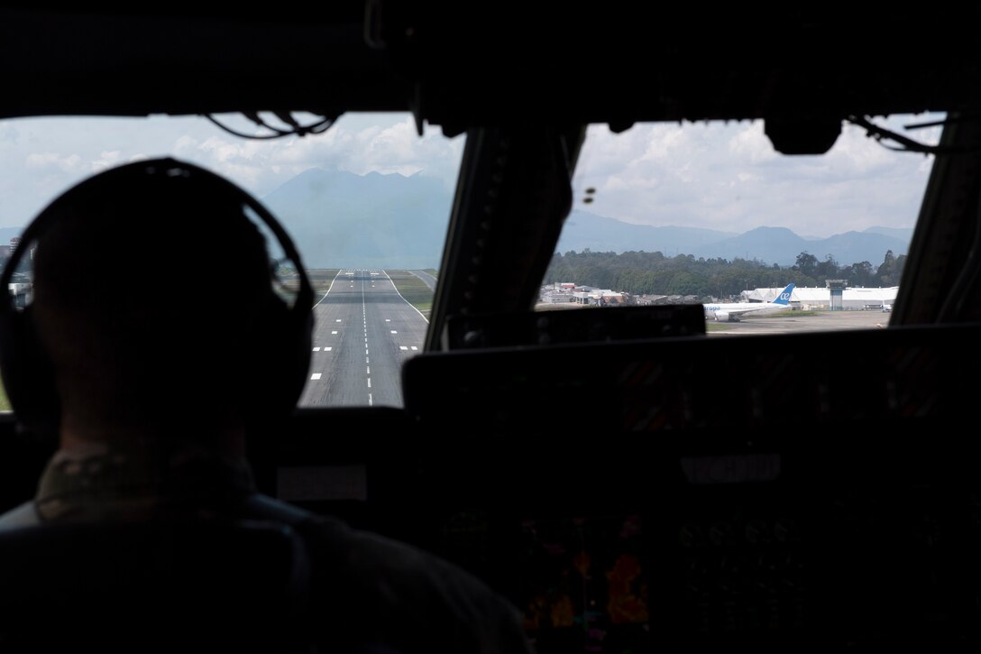 Photos of 22nd Airlift Squadron Airmen loading humanitarian aid at Travis AFB and delivering it to Guatemala.