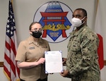 YOKSUKA, Japan (Mar. 10, 2021) Information Systems Technician 2nd Class Morgan Marsh, a native of Sparks, Nevada, receives her frocking letter during her pinning ceremony held at Commander, Submarine Group 7. (U.S. Navy photo by Mass Communication Specialist 2nd Class Adam K. Thomas)