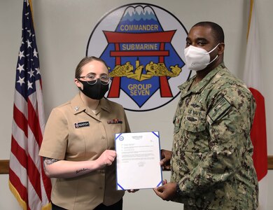 YOKSUKA, Japan (Mar. 10, 2021) Information Systems Technician 2nd Class Morgan Marsh, a native of Sparks, Nevada, receives her frocking letter during her pinning ceremony held at Commander, Submarine Group 7. (U.S. Navy photo by Mass Communication Specialist 2nd Class Adam K. Thomas)