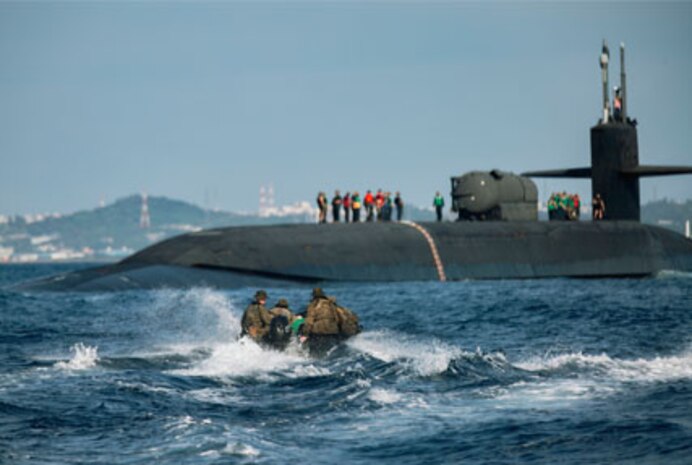 PHILIPPINE SEA (Feb. 2, 2021) -- U.S. Marines from Force Reconnaissance Company, III Marine Expeditionary Force (MEF), utilize combat rubber raiding crafts to approach the Ohio-class guided-missile submarine USS Ohio (SSGN 726), deployed in the U.S. 7th Fleet area of operations, during an integration exercise off the coast of Okinawa, Japan. The exercise was part of ongoing III MEF-U.S. 7th Fleet efforts to provide flexible, forward-postured and quick-response options to regional commanders. (U.S Marine Corps photo by Sgt. Destiny Dempsey)