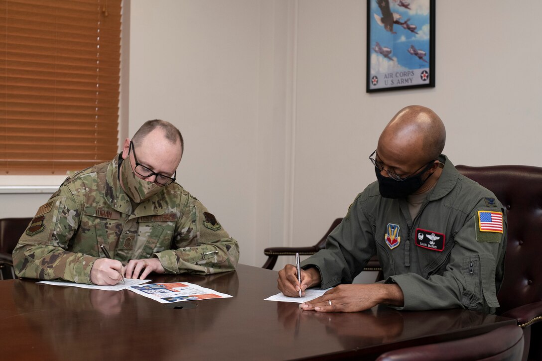A photo of leadership filling out AFAF form for a story.