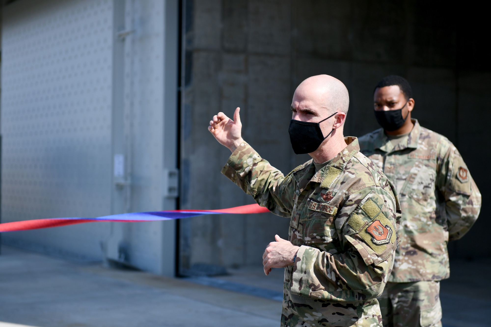 U.S. Air Force Brig. Gen. Jason Bailey, 31st Fighter Wing commander, speaks to guests at a ribbon cutting ceremony for new munitions storage modules on Area F at Aviano Air Base, Italy, March 31, 2021. The three modules will allow 31st Munitions Squadron Airmen to pre-position munitions on the flightline, allowing faster delivery without the requirement of shutting down the highway between Areas F and G. (U.S. Air Force photo by Staff Sgt. K. Tucker Owen)