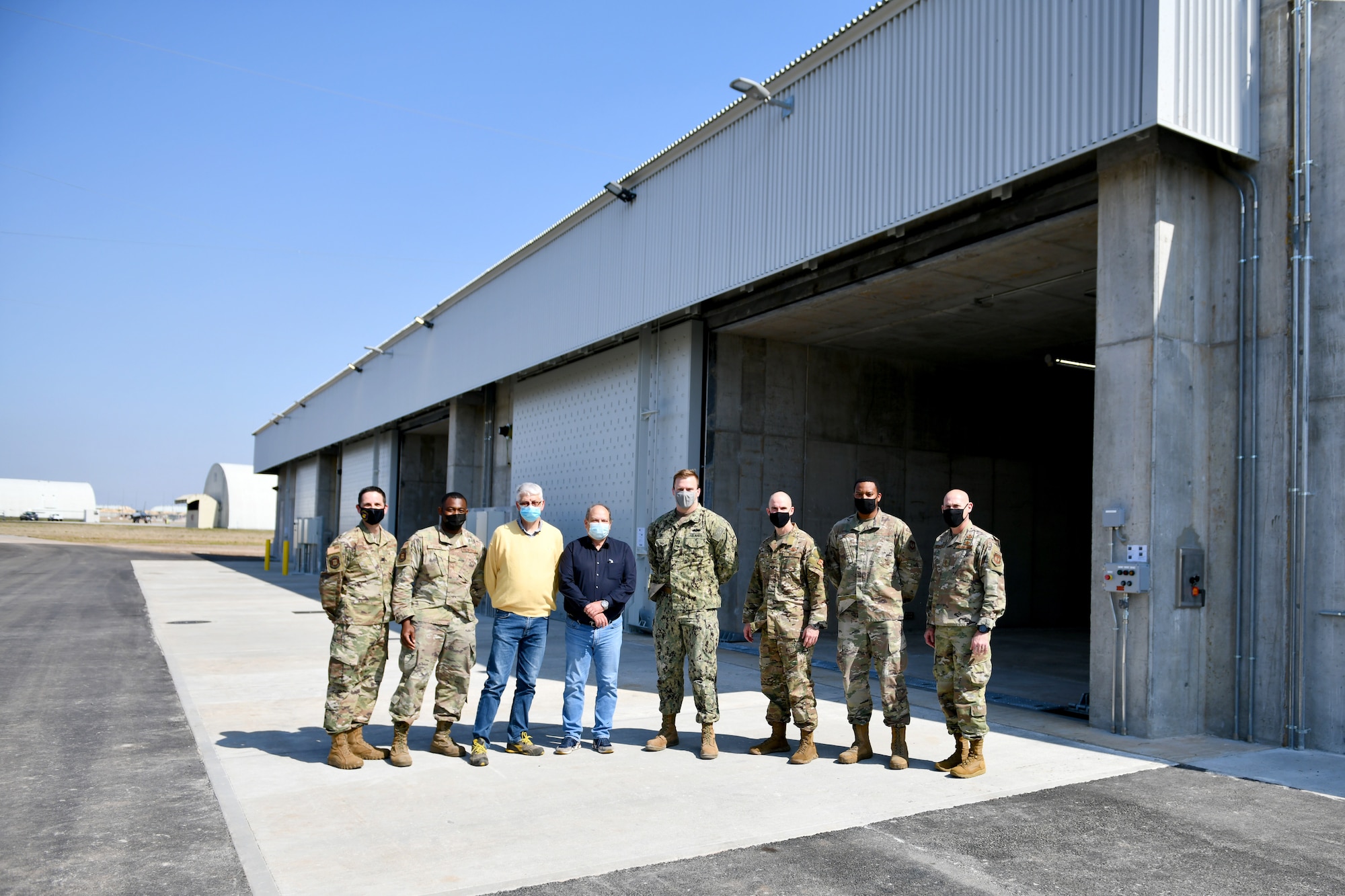 U.S. Air Force, U.S. Navy and contracting personnel, along with 31st Fighter Wing leadership, stand before three new earth-covered munitions storage modules on Area F at Aviano Air Base, Italy, March 31, 2021. Planning for the modules began in 2014, with construction starting March 2020 and finishing one year later. (U.S. Air Force photo by Staff Sgt. K. Tucker Owen)