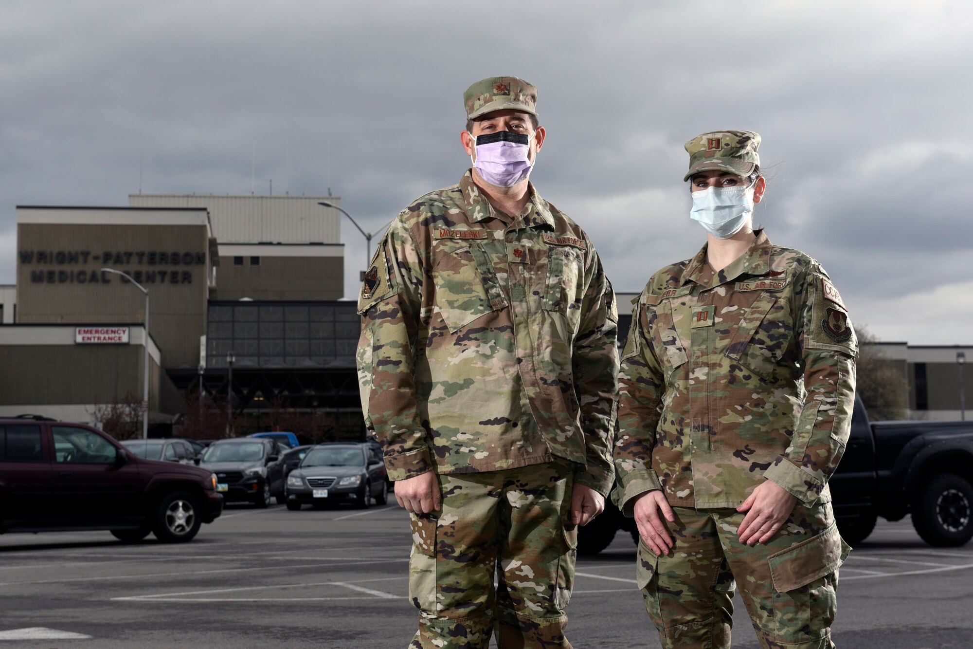 Air Force Maj. Eric Mozeleski, an emergency medicine physician with the 88th Medical Group, and Capt. Carly Kerr, a critical care nurse with 88 MDG, talk outside the Wright Patterson Air Force Base, Ohio, Medical Center on March 31, 2021. Both Mozeleski and Kerr became first responders on March 23 when they attended to rollover auto accident victims as they commuted to work at Wright-Patt. Mozeleski and Kerr stabilized two victims and waited for emergency services to arrive. (U.S. Air Force photo by Ty Greenlees)