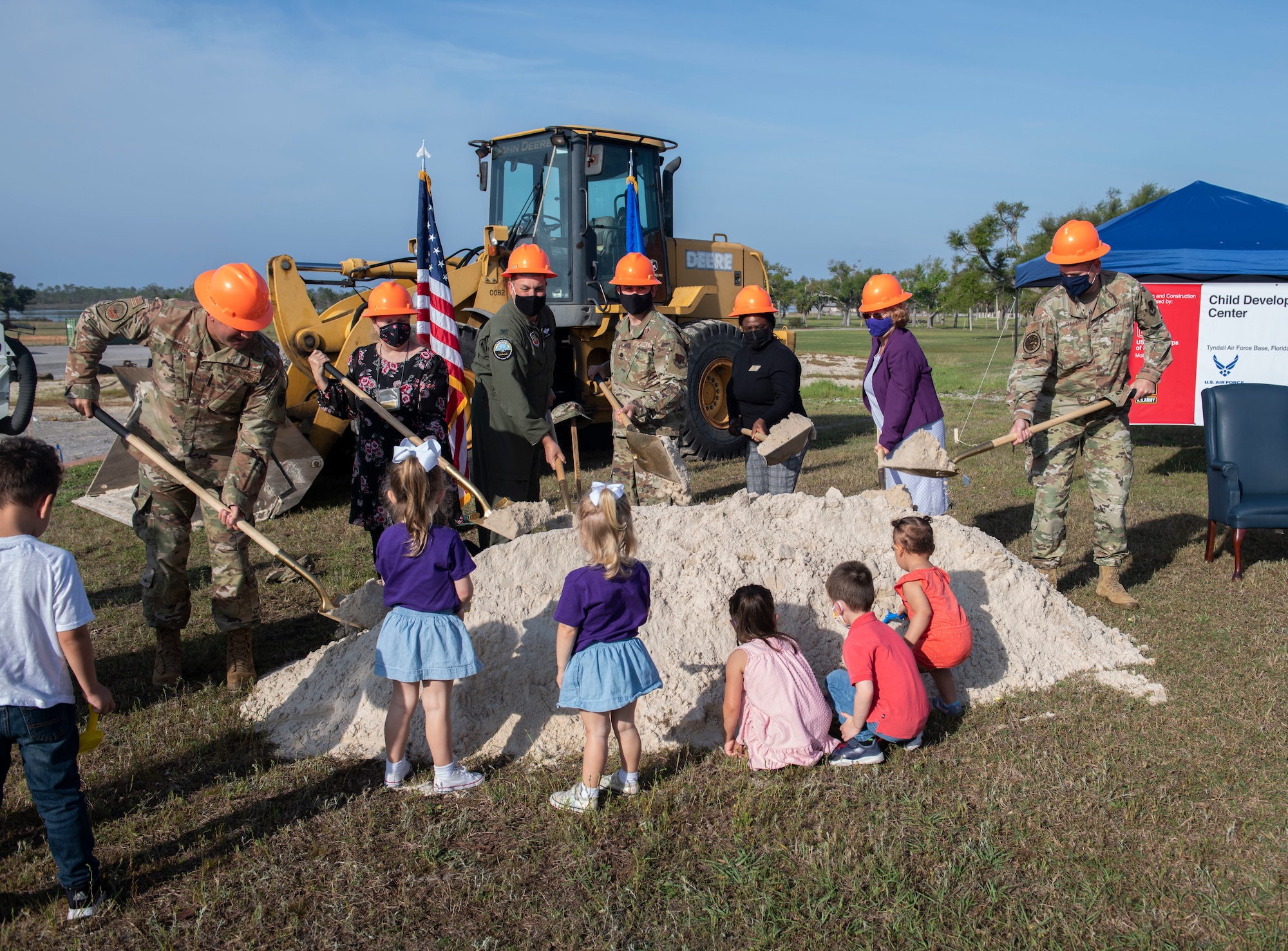 A group participates in a ground breaking ceremony