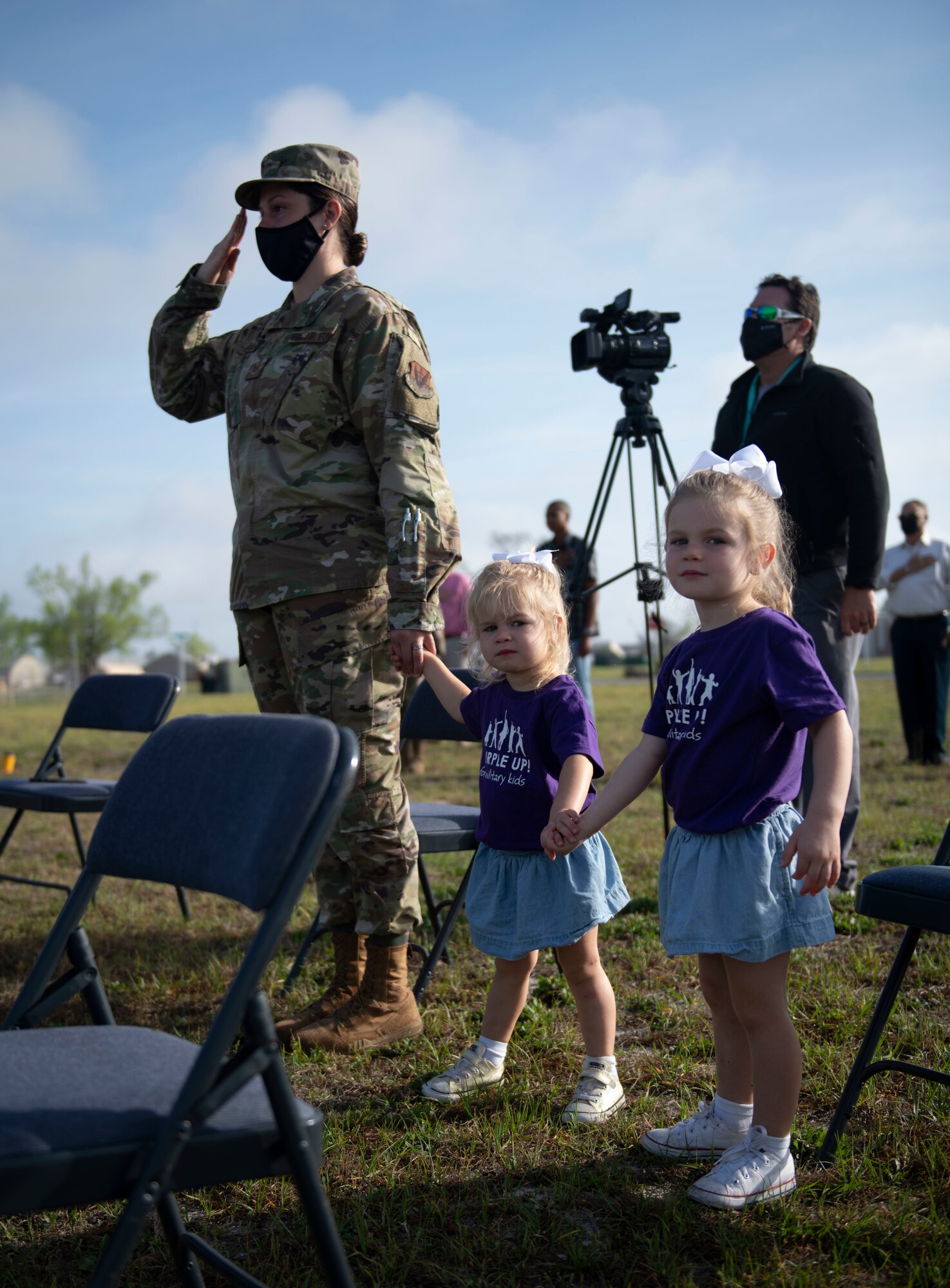 An Airman and her childrean stand together