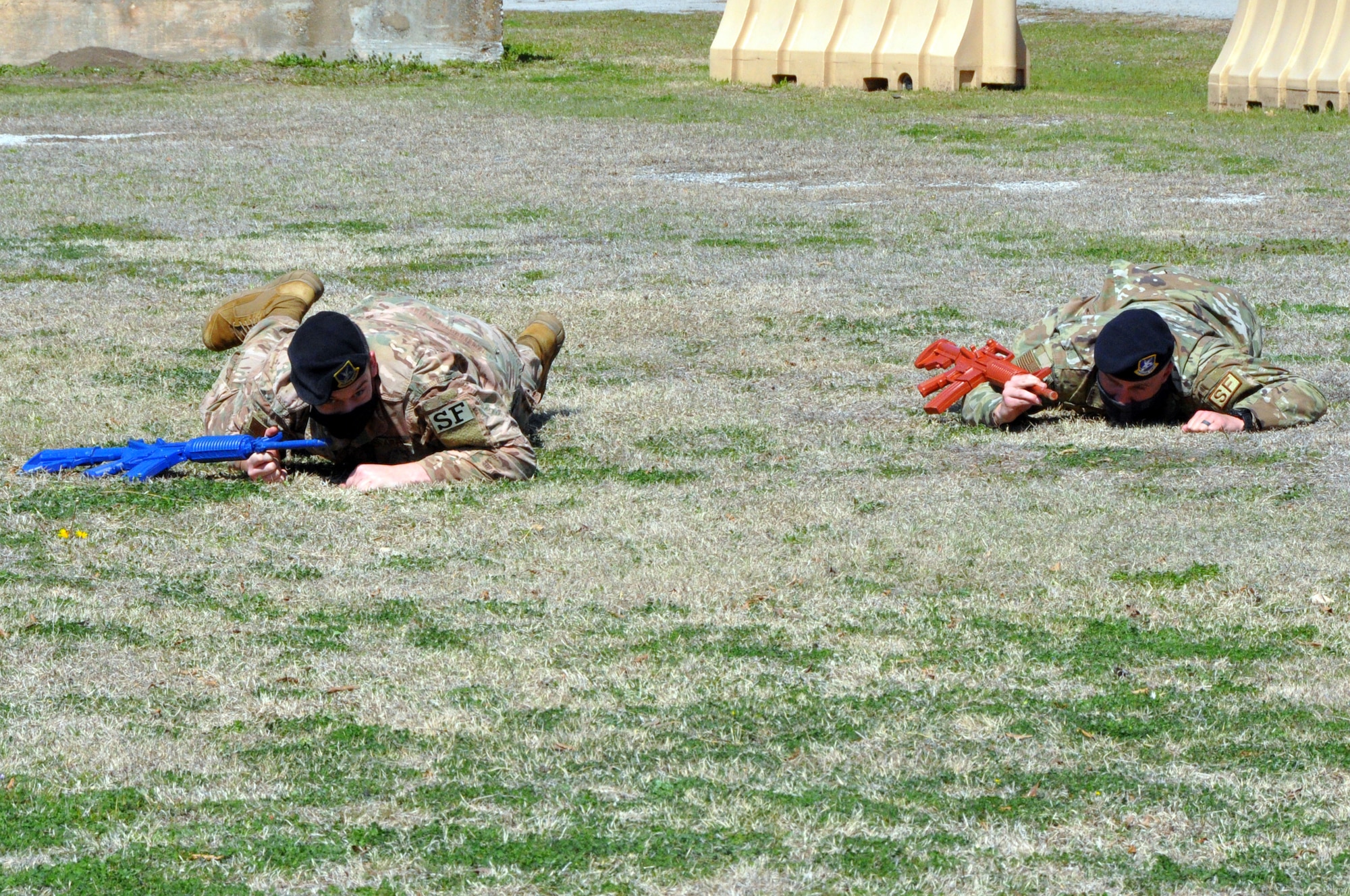 301st Fighter Wing Security Forces Squadron fire team members, (Left) Staff Sgt. Timothy Hobson and (right) Airman First Class Ryan Gomas low crawl as part of fire team movements during a field training exercise at U.S. Naval Air Station Joint Reserve Base Fort Worth, Texas on March 6, 2021. Repetitious maneuvers and team work creates a more cohesive training environment, ensuring when the time comes for them to protect, defend and fight. (U.S. Air Force photo by Senior Airman William Downs)
