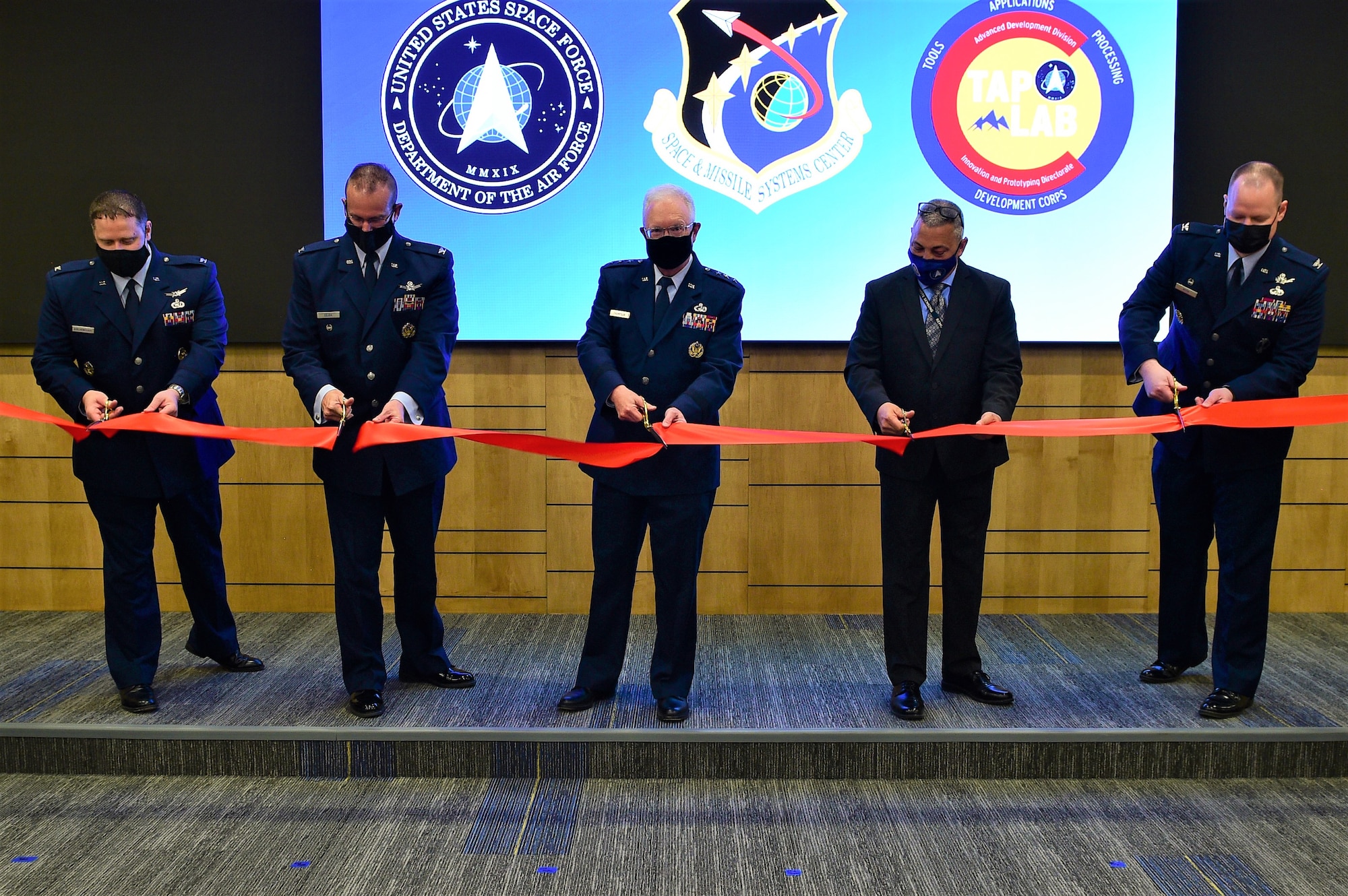 SMC hosted a grand re-opening ribbon-cutting ceremony to unveil the new renovated state-of-the-art TAP Lab on Mar. 31, 2021 in Boulder, Colo. Pictured in the ribbon-cutting are (l-r) Col Dennis Birchenough, Senior Material Leader, Advanced Development Division, Col. Timothy A. Sejba, program executive officer, Space Development, Lt. Gen. John F. Thompson, SMC commander and program executive officer for Space, Steven Polliard,  Director, TAP Lab and Col. Joseph J. Roth, Director, SMC’s Innovation and Prototyping Directorate.  (U.S. Space Force photo by Senior Airman Danielle McBride)