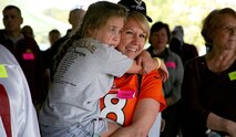 Kerrie Branson, Survivor Outreach Services coordinator for Redstone Arsenal, Alabama, holds Gold Star Family member Kylee Little during a U.S. Army Space and Missile Defense Command-sponsored fall festival at the Huntsville Botanical Gardens on Oct. 18, 2014. Little is the daughter of Spc. Kyle Little, 20, who was killed in action in Salman Pak, Iraq, on May 8, 2007. (U.S. Army photo by Carrie David Campbell)