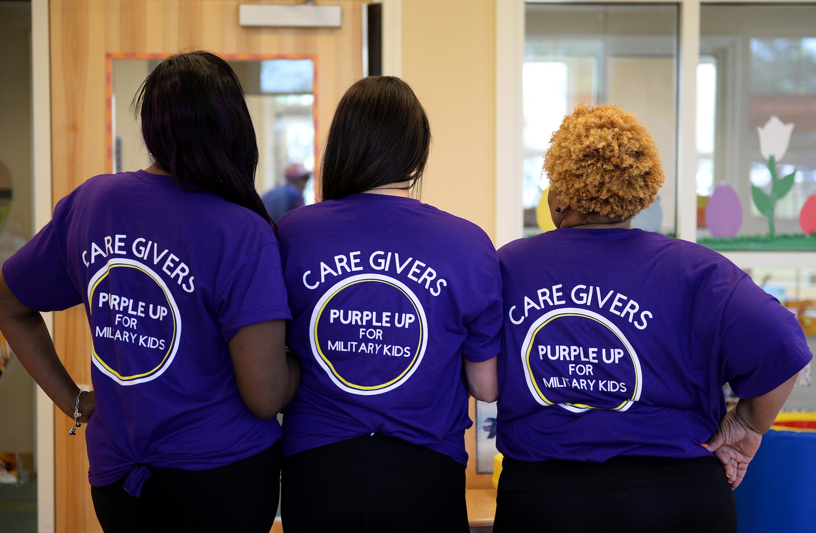 Caregivers wear Purple Up t-shirts.