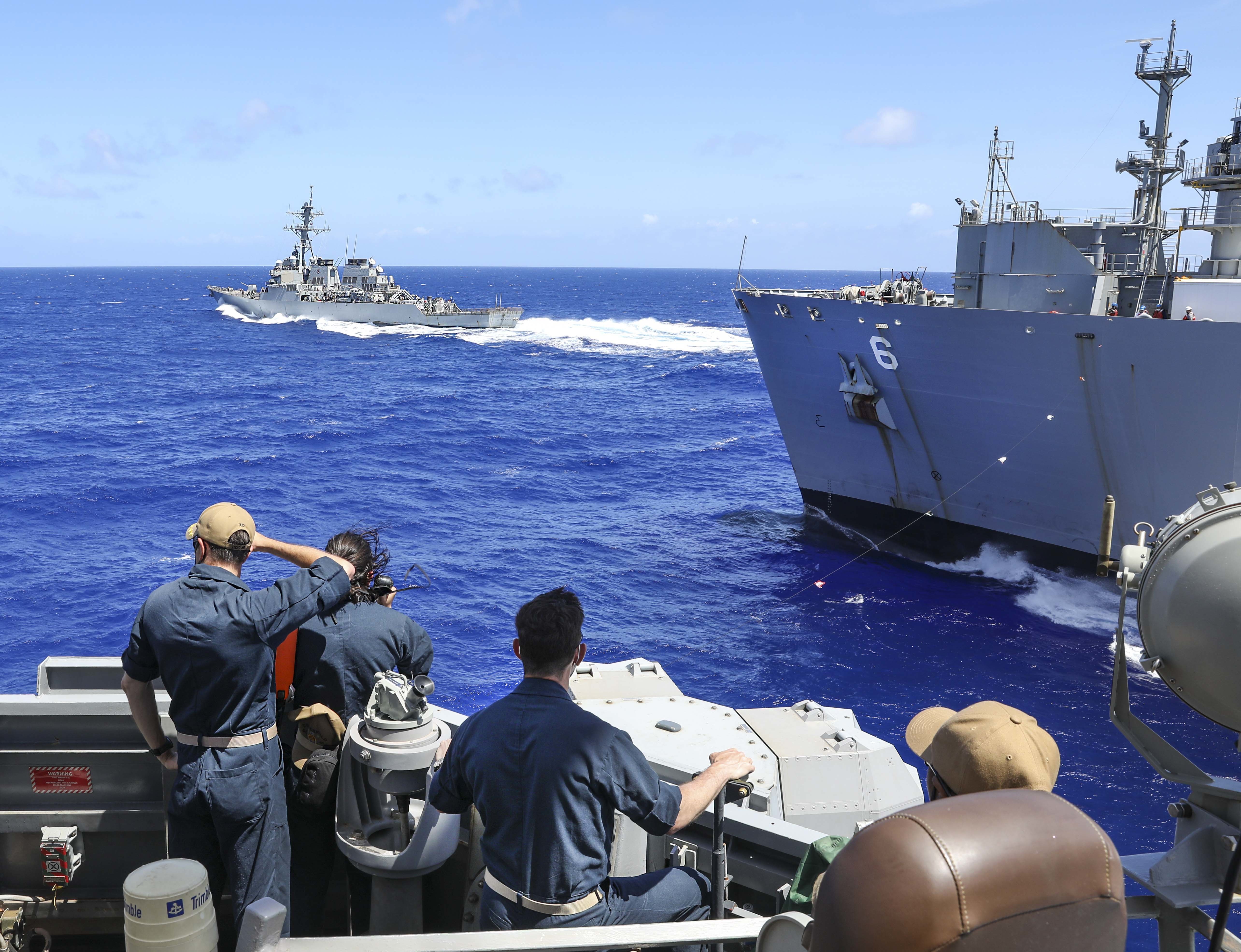 USS Benfold (DDG 65) conducts a replenishment-at-sea with USNS Amelia Earhart (T-AKE 6) while the USS John S. McCain (DDG 56) conducts a break away.