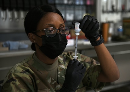 U.S. Army Spc. Shaquondre Berry, combat medic, Michigan Medical Detachment, Michigan Army National Guard, draws a COVID-19 vaccine during a vaccination clinic March 24, 2021, at Joint Forces Headquarters in Lansing, Michigan. The clinic provided vaccines to approximately 250 Department of Defense personnel and other Tricare eligible recipients.