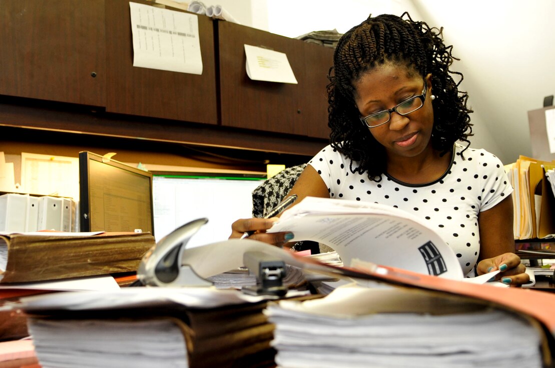 contracting officer looks over a file