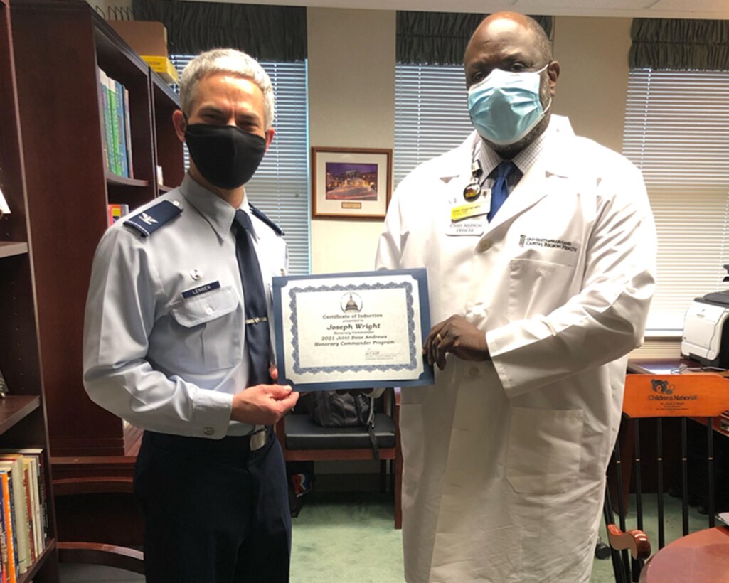 Col. Jason Lennen, 316th Medical Group commander, presents an induction certificate to Dr. Joseph Wright, senior vice president and chief medical officer, University of Maryland School of Medicine/Capital Region Health, in preparation for the virtual Honorary Commanders Program ceremony on Joint Base Andrews, Md., March 25, 2021. The JBA Honorary Commanders Program encourages an exchange of ideas and experiences, as well as partnerships between key leaders of the base's surrounding communities, JBA commanders and Airmen. (U.S. Air Force courtesy photo)