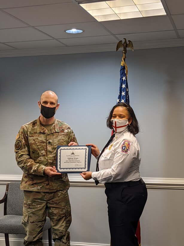 Lt. Col. Ross Dotzlaf, 316th Civil Engineering Squadron commander, presents an induction certificate to Ms. Tiffany Green, Prince George’s County fire chief, in preparation for the virtual Honorary Commanders Program ceremony on Joint Base Andrews, Md., March 25, 2021. The JBA Honorary Commanders program is intended to help reinforce the bond between the base and members of the community while increasing the community’s awareness of the joint base mission. (U.S. Air Force courtesy photo)
