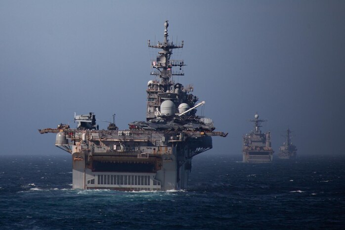U.S. Navy ships of the Iwo Jima Amphibious Ready Group, embarked with the 24th Marine Expeditionary Unit, simulate a strait transit during Composite Unit Training exercise off the Atlantic coast, March 1, 2021. COMPTUEX is a month-long training event designed to test the ARG-MEU’s capabilities against the full spectrum of military operations.