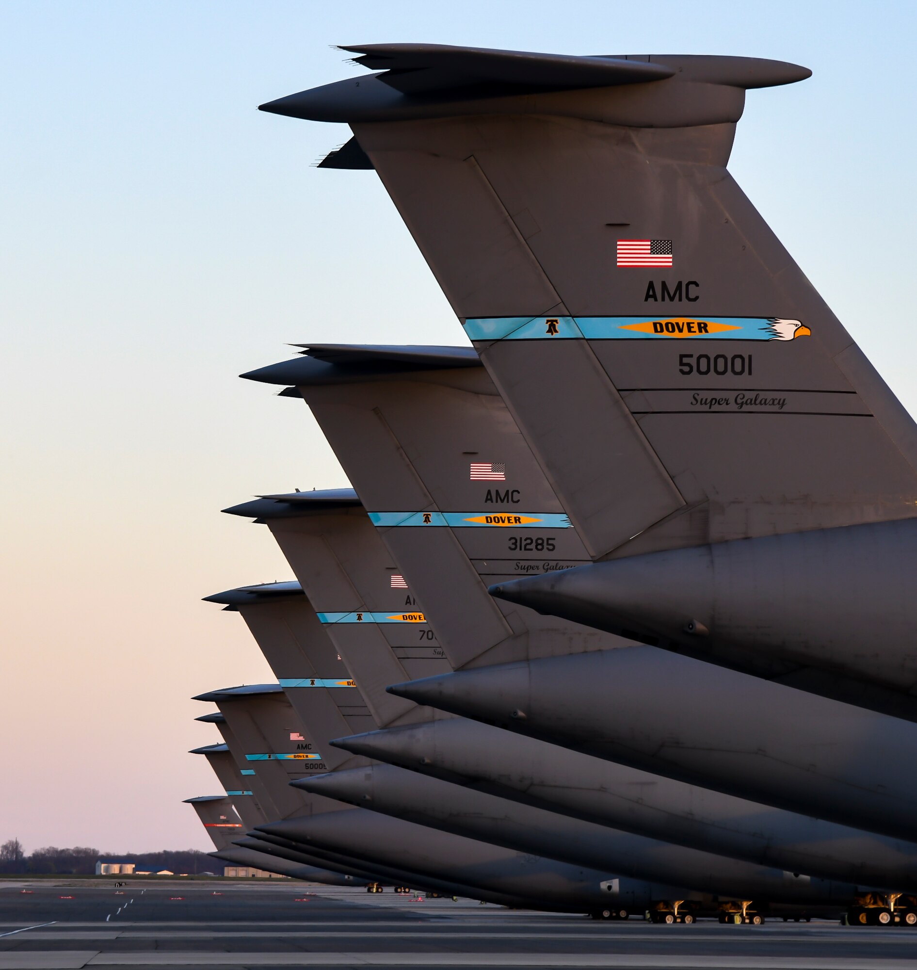 The sun sets over C-5M Super Galaxy aircraft on the flight line at Dover Air Force Base, Delaware, March 30, 2021. The 436th Airlift Wing owns, maintains and operates the C-5M Super Galaxy and C-17 Globemaster III aircraft with a mission to provide rapid global airlift, combat ready Airmen and unrivaled installation support. (U.S. Air Force photo by Airman 1st Class Stephani Barge)
