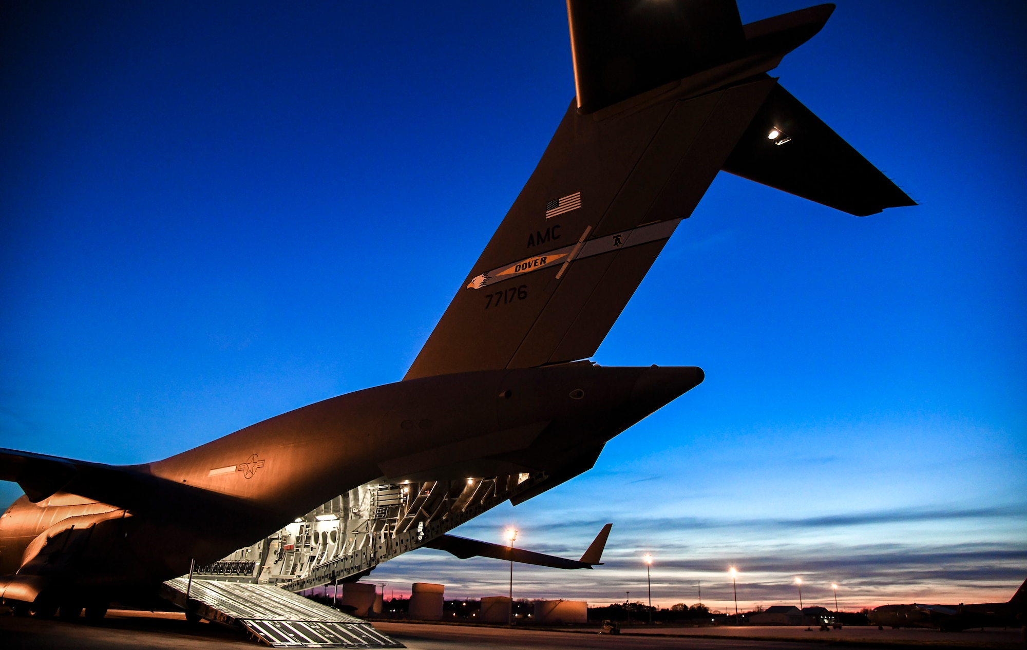 The sun sets over a C-17 Globemaster III aircraft on the flight line at Dover Air Force Base, Delaware, March 30, 2021. The 436th Airlift Wing owns, maintains and operates C-5M Super Galaxy and C-17 Globemaster III aircraft with a mission to provide rapid global airlift, combat ready Airmen and unrivaled installation support. (U.S. Air Force photo by Airman 1st Class Stephani Barge)
