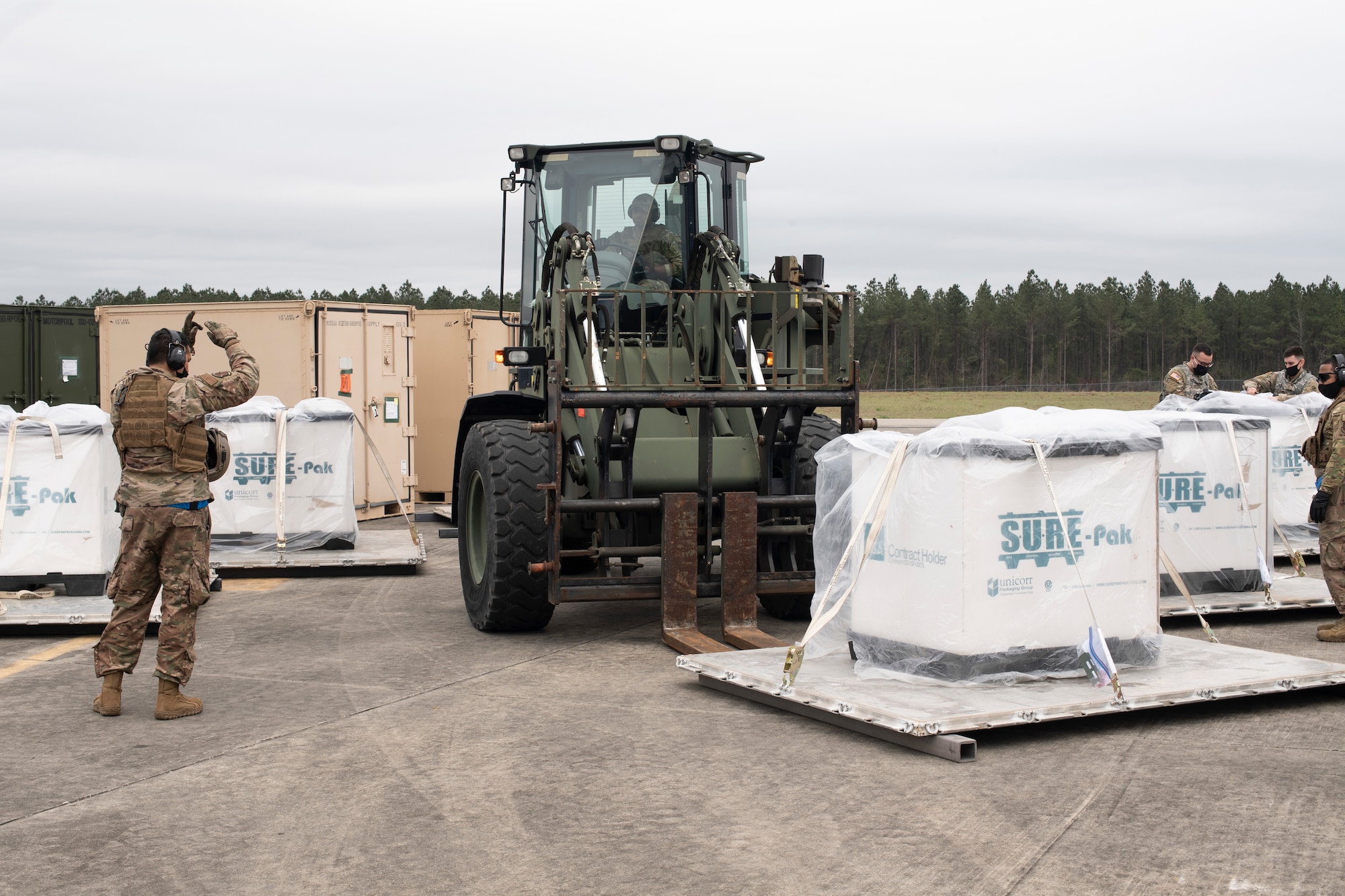 Aerial porters from the 321st Contingency Response Squadron process pallets of simulated relief supplies March 26, 2021, during Exercise Turbo Distribution 21-2 at Camp Shelby, Mississippi. Turbo Distribution is a joint task force port opening aerial port of debarkation field training exercise that was held March 24-31. Participating units included the 621st Contingency Response Group stationed at Joint Base McGuire-Dix-Lakehurst, New Jersey, and the U.S. Army 688th Rapid Port Opening Element stationed at Joint Base Langley-Eustis, Virginia. (U.S. Air Force photo by Tech. Sgt. Luther Mitchell)