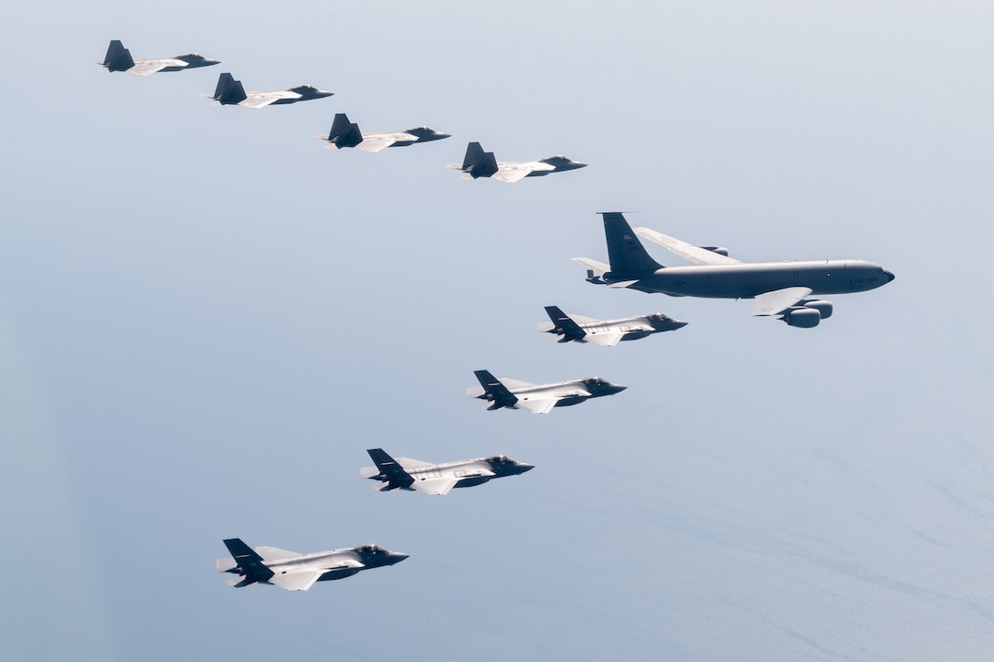 Aircraft fly in formation.