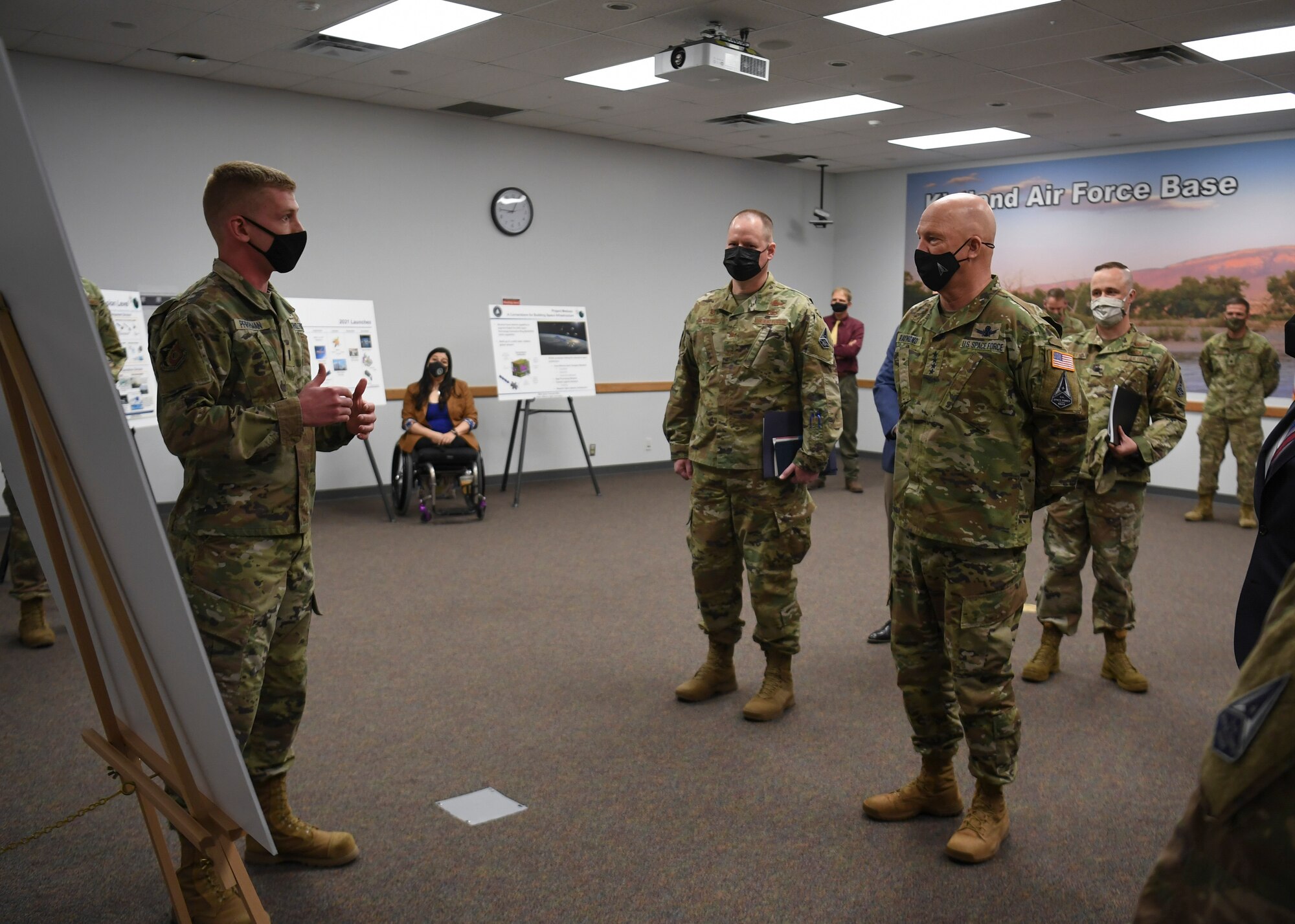 Military member speaks to other military members in room
