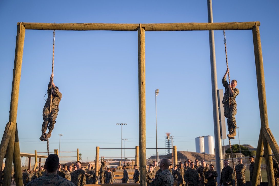 U.S. Marines and Sailors with Headuarters and Headquarters Squadron, Marine Corps Air Staion (MCAS) Yuma, participate in a squadron-wide obstacle course exercise on Nov. 8, 2019. The Marine Corps obstacle course is composed of various obstacles such as high and low logs, high bars, incline bars and traverse logs, and a rope climb. (Marine Corps photo by Lance Cpl. John Hall)