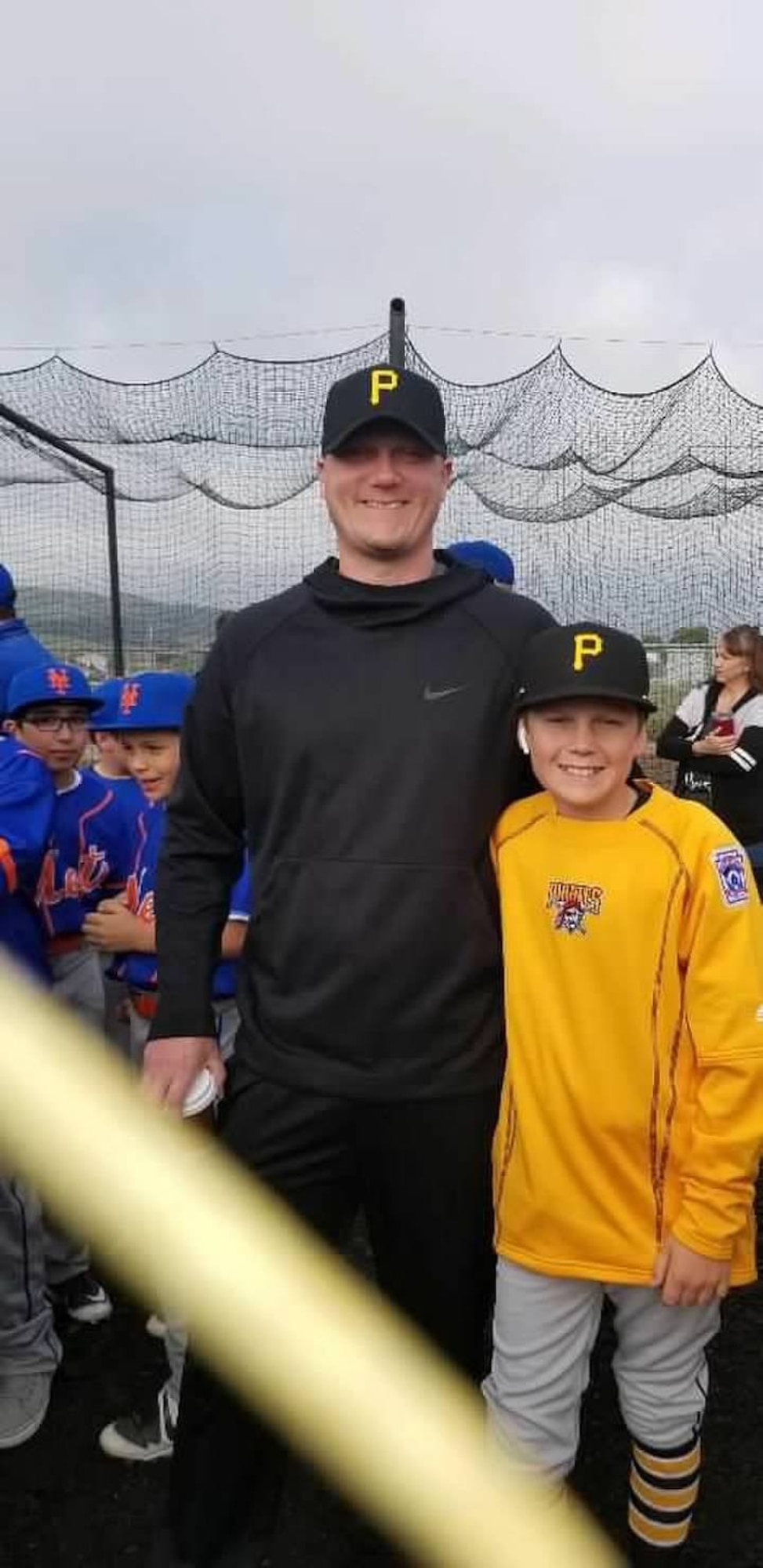 Nathan Lancor poses with his son at one of the traveling teams games