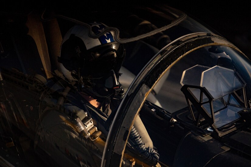 A U.S. Marine conducts flight operations aboard Wasp-class amphibious assault ship USS Essex (LHD 2), March 21.