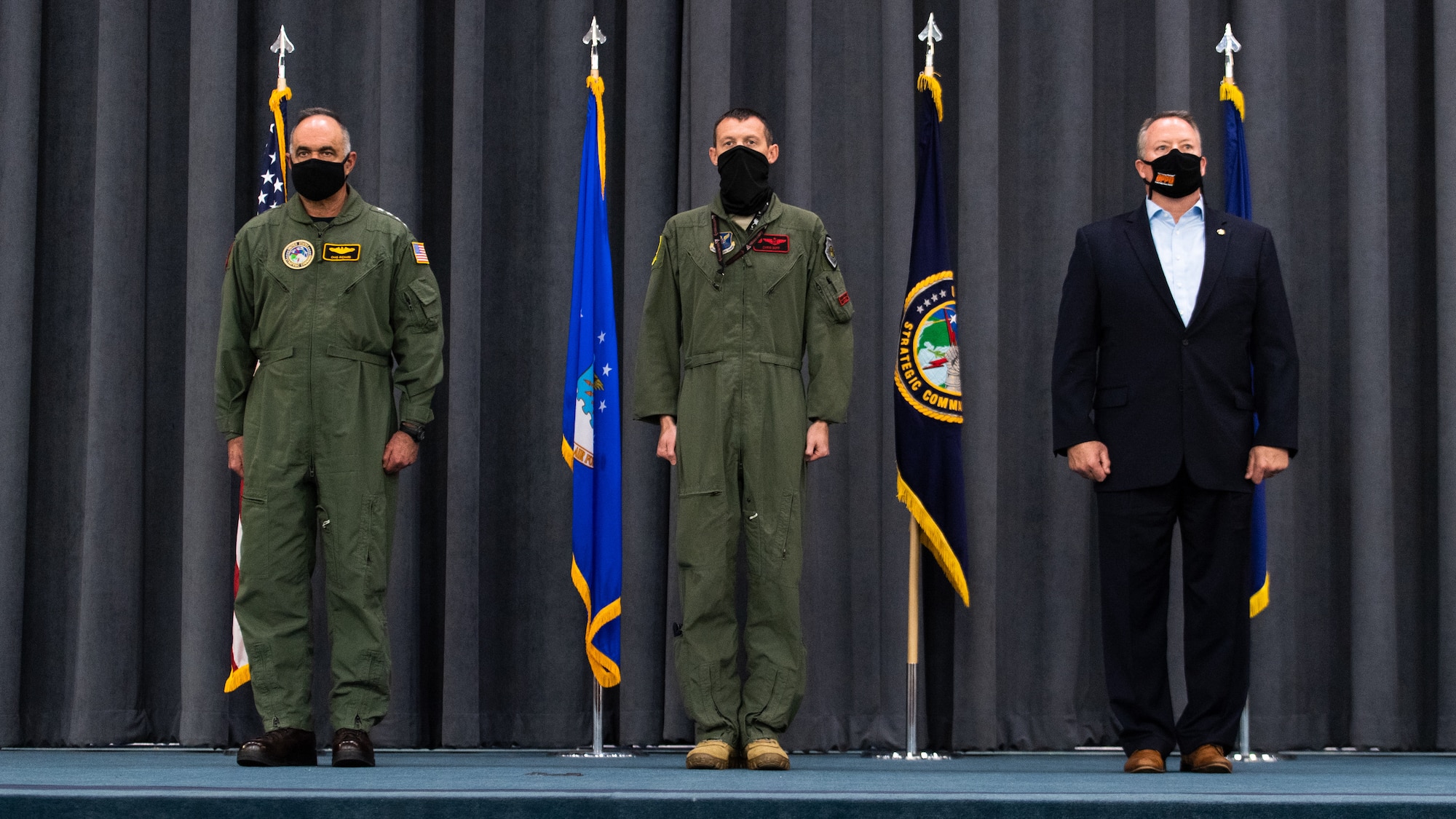 (Left to right) Adm. Charles Richard, U.S. Strategic Command commander, Lt. Col. Christopher Duff, 96th Bomb Squadron commander, and Mr. Tim Burke, Strategic Command Consultation Committee chairman, stand at the position of attention during the presentation of the Omaha Trophy to the 96th BS at Barksdale Air Force Base, Louisiana, March 30, 2021.The Omaha Trophy is awarded each year to various units in recognition of outstanding support to USSTRATCOM's strategic deterrence mission (U.S. Air Force photo by Airman 1st Class Jacob B. Wrightsman)