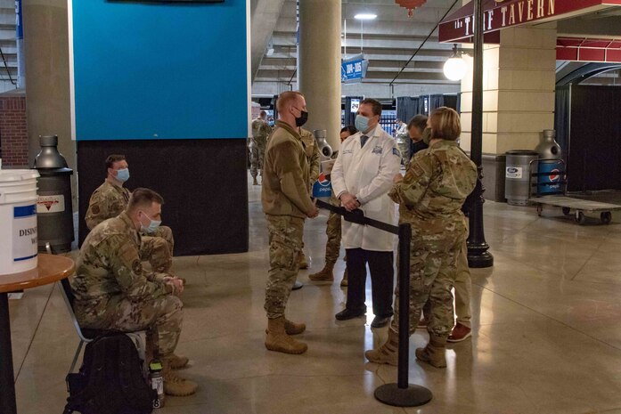 Dr. Steven Rockoff, member of the Henry Ford Health System and Medical Director for the state-run, federally-supported Ford Field COVID-19 Community Vaccination Center in Detroit, speaks to U.S. Air Force Airmen about operational procedures, March 22, 2021. When open, the center will be able to administer up to 6,000 vaccinations a day. U.S. Northern Command, through U.S. Army North, remains committed to providing flexible Department of Defense support to the whole-of-government COVID-19 response. (U.S. Army photo by Spc. Andrew Wash, 5th Mobile Public Affairs Detachment)