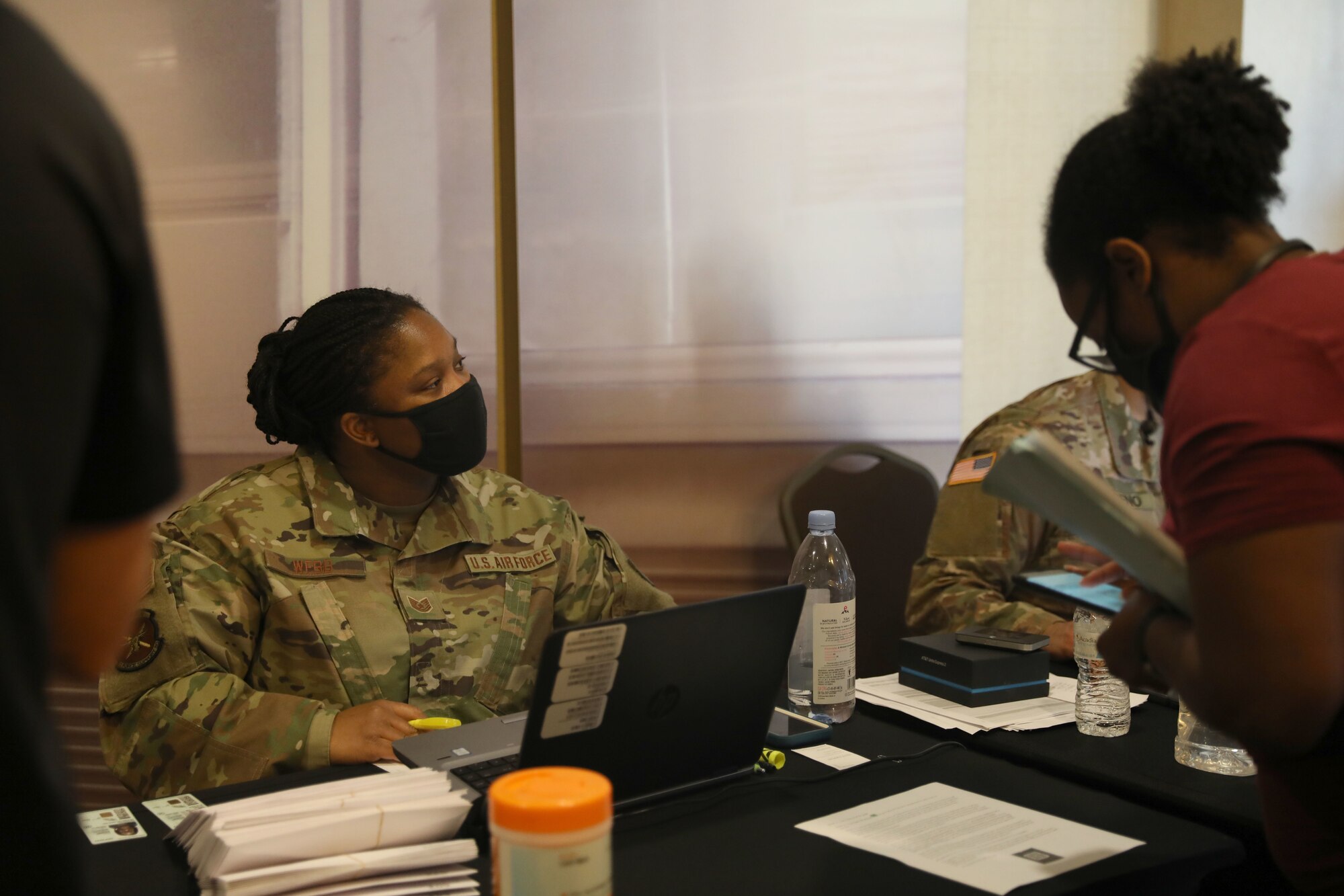 U.S. Air Force Tech Sgt. Tanika Webb, a Sanders Field, Georgia, native and personnel specialist assigned to the 7th Force Support Squadron, checks in Airmen that will support the state-run, federally-supported COVID-19 Community Vaccination Center