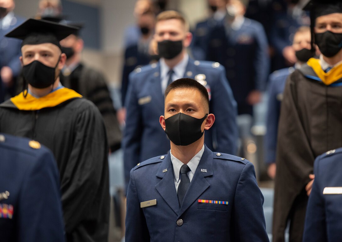 U.S. Air Force 2nd Lt. Benjamin Lam and his classmates take their seats at the start of the Air Force Institute of Technology graduation ceremony March 25, 2021, on Wright-Patterson Air Force Base, Ohio. Approximately 250 advanced degrees were awarded to Airmen, Space Force Guardians, Soldiers, Marines and Air Force civilians. (U.S. Air Force photo by R.J. Oriez)