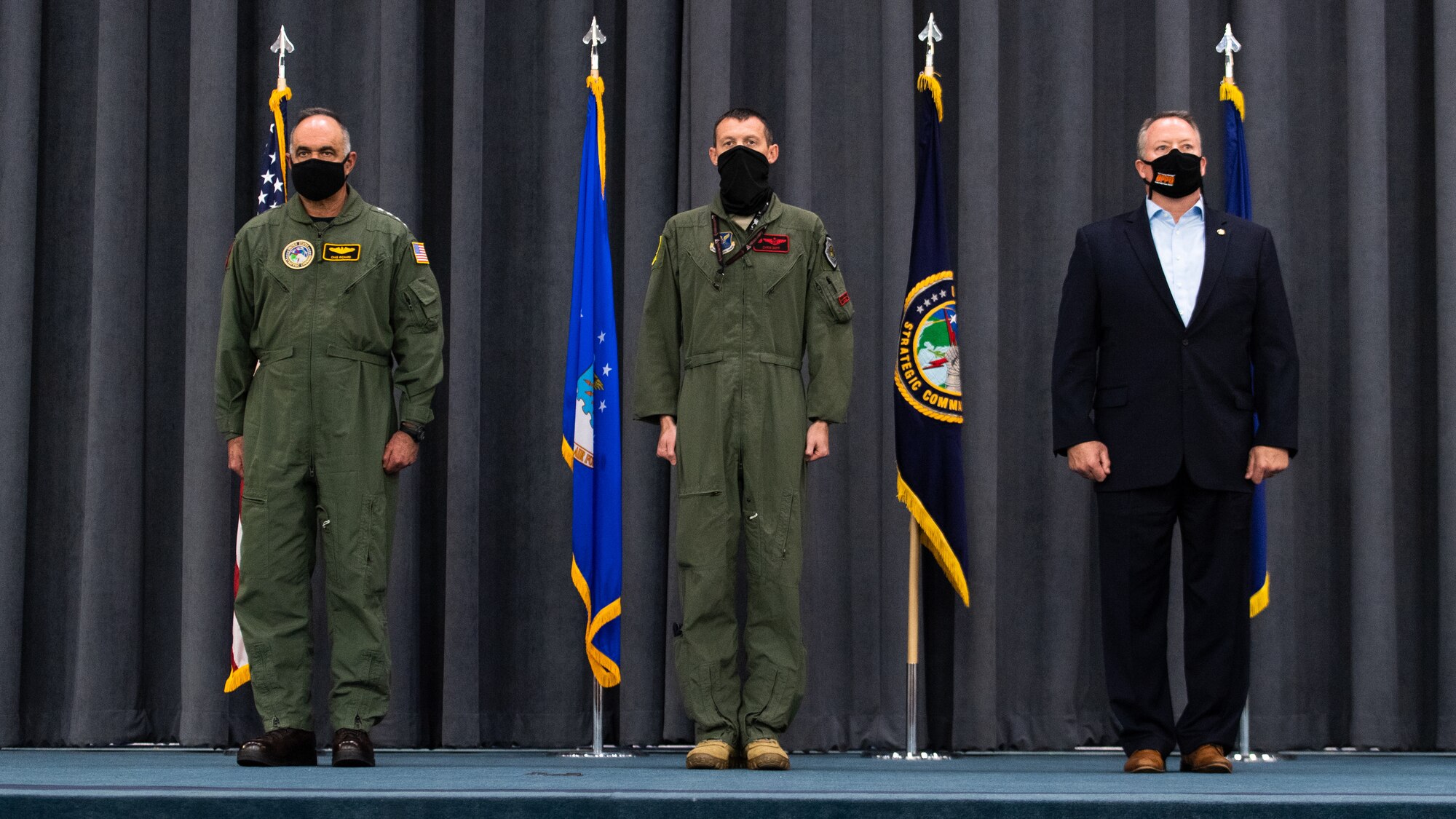 (Left to right) Adm. Charles Richard, U.S. Strategic Command commander, Lt. Col. Christopher Duff, 96th Bomb Squadron commander, and Mr. Tim Burke, Strategic Command Consultation Committee chairman, stand at the position of attention during the presentation of the Omaha Trophy to the 96th BS at Barksdale Air Force Base, Louisiana, March 30, 2021.The Omaha Trophy is awarded each year to various units in recognition of outstanding support to USSTRATCOM's strategic deterrence mission (U.S. Air Force photo by Airman 1st Class Jacob B. Wrightsman)