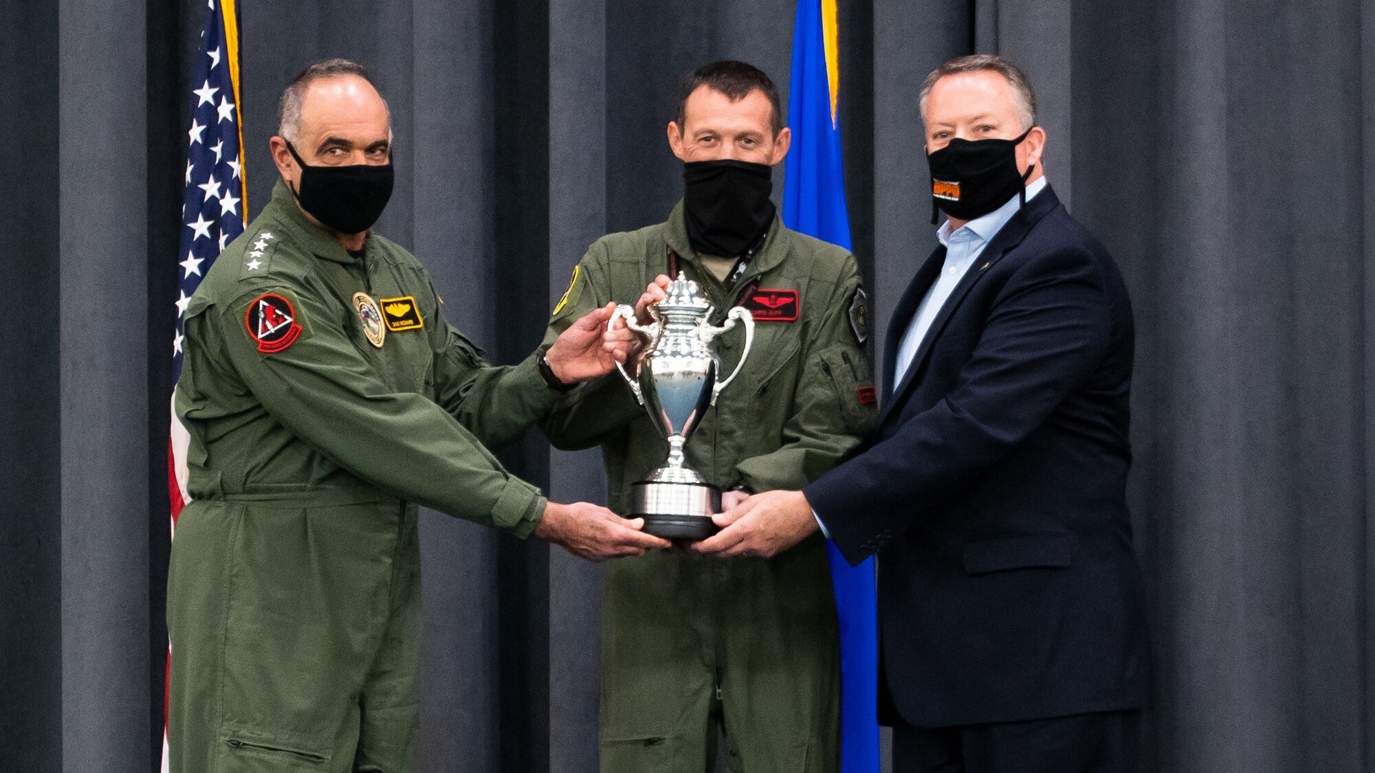 (Left to right) Adm. Charles Richard, U.S. Strategic Command commander, Lt. Col. Christopher Duff, 96th Bomb Squadron commander, and Mr. Tim Burke, Strategic Command Consultation Committee chairman, hold the Omaha Trophy during the presentation of the Omaha Trophy to the 96th BS at Barksdale Air Force Base, Louisiana, March 30, 2021. The 96th BS is the first bomb squadron to be presented the prestigious award. (U.S. Air Force photo by Airman 1st Class Jacob B. Wrightsman)