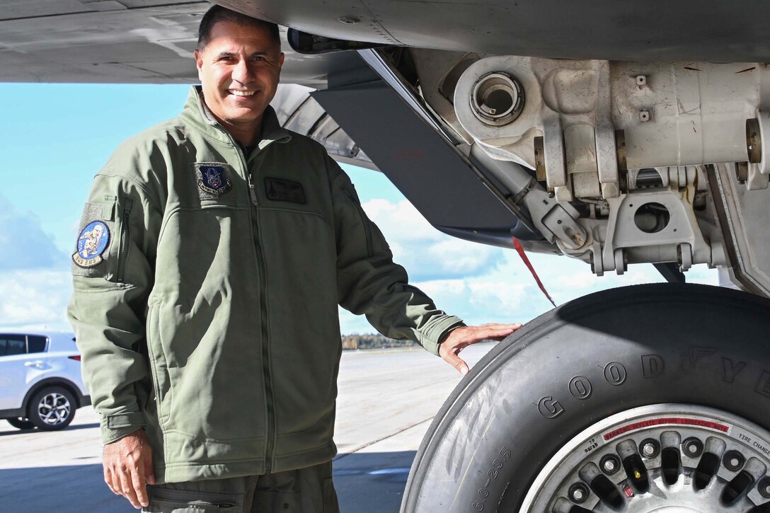 Photo of an Airman standing by the wheel of a B-1 Lancer bomber.