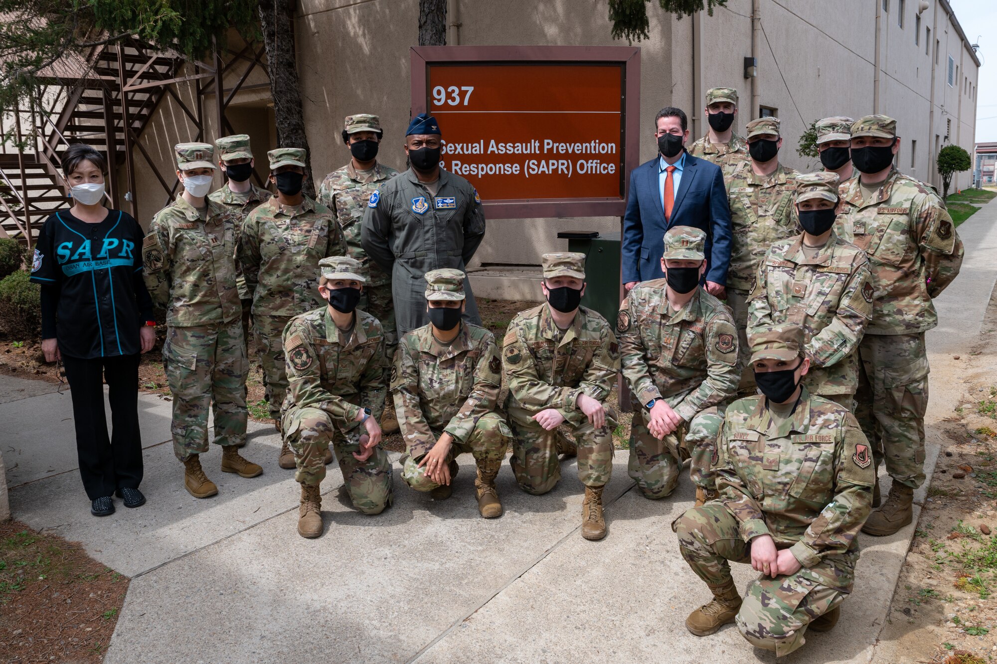 Sexual Assault Prevention and Response staff, volunteer victim advocates and Col. Henry Jeffress, 51st Fighter Wing vice commander, poses for a group photo at Osan Air Base, Republic of Korea, April 1, 2021. SAPR VVAs provide essential support and care to victims by assisting them in making informed decisions as they progress through resolution and healing. (U.S. Air Force photo by Senior Airman Branden Rae)