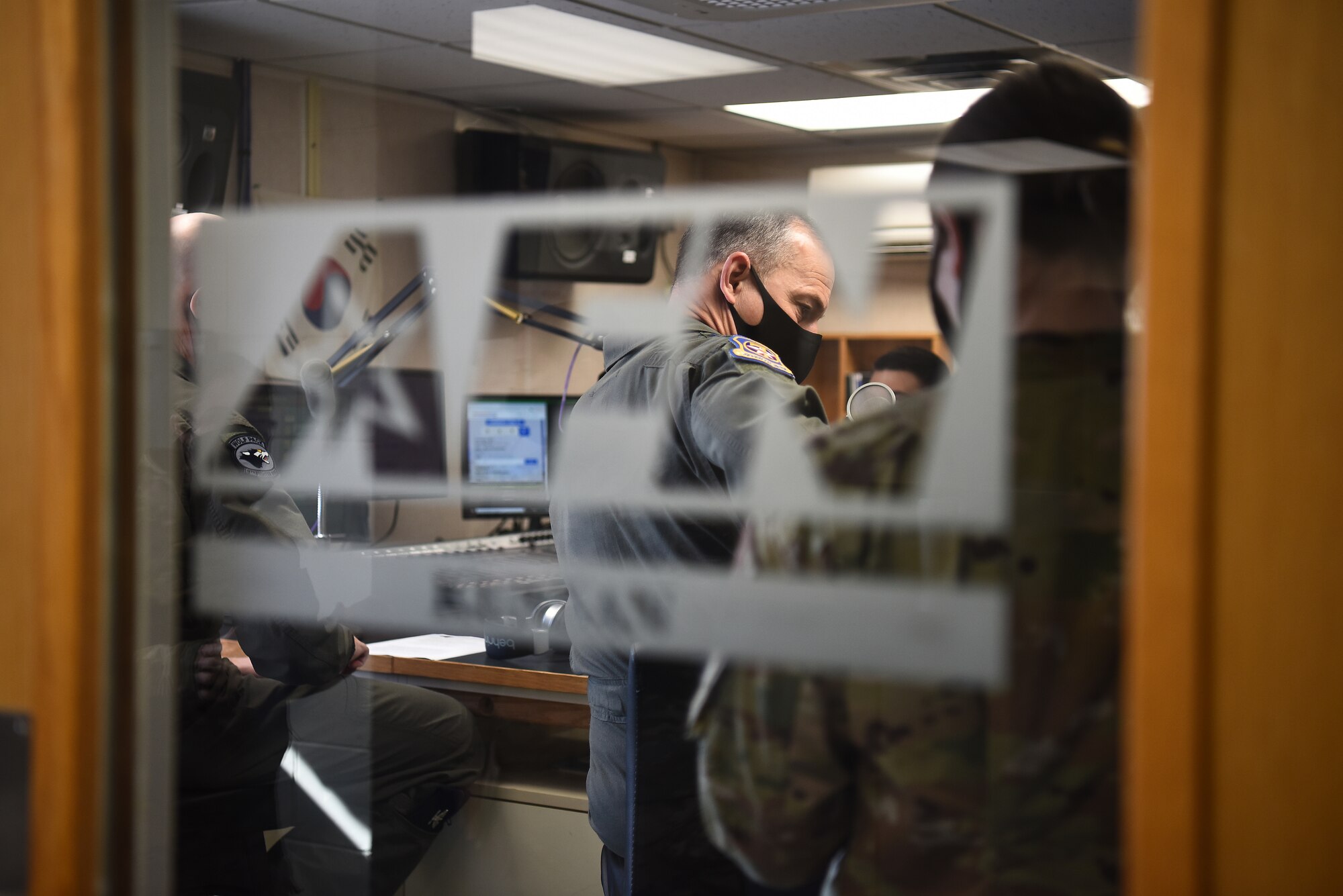 Lt. Gen. Scott Pleus, 7th Air Force commander, prepares for a live radio broadcast at American Forces Network Kunsan at Kunsan Air Base, Republic of Korea, April 1, 2021. During his visit, Pleus held a mentorship session with Kunsan’s company grade officers, toured the O’Malley Dining Facility, visited the fighter squadrons and more. (U.S. Air Force photo by Senior Airman Suzie Plotnikov)