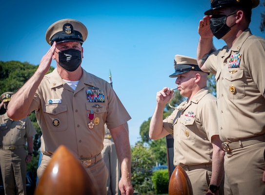 Master Chief Petty Officer of the Navy Russell Smith pipes Force Master Chief James Osborne ashore during a retirement ceremony at Naval Amphibious Base Coronado.