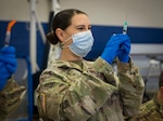 Sgt. 1st Class Sara Landon, Connecticut Army National Guard Medical Detachment readiness noncommissioned officer, prepares vials of Pfizer COVID-19 vaccine during a vaccination clinic at Naval Submarine Base New London in Groton, Connecticut, April 1, 2021. The Connecticut National Guard partnered with the base to distribute vaccines to approximately 1,000 Sailors and eligible Navy personnel.